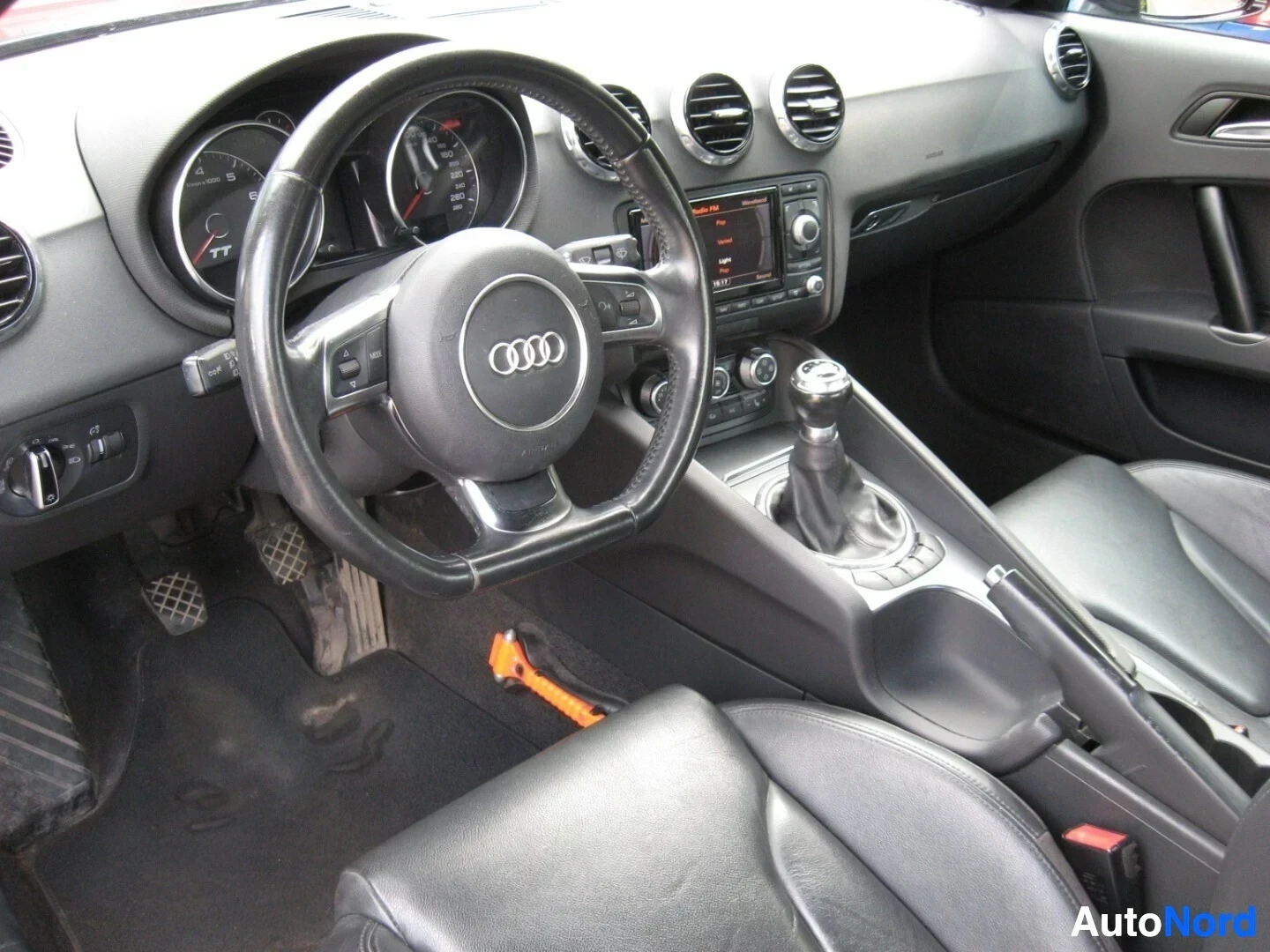 Ohjaamo: Audi TT:n sisusta kuvattu kuljettajan paikalta, harmaa nahkaverhoilu, Audi-logoinen ohjauspyörä, näkyvissä instrumentit ja keskikonsoli