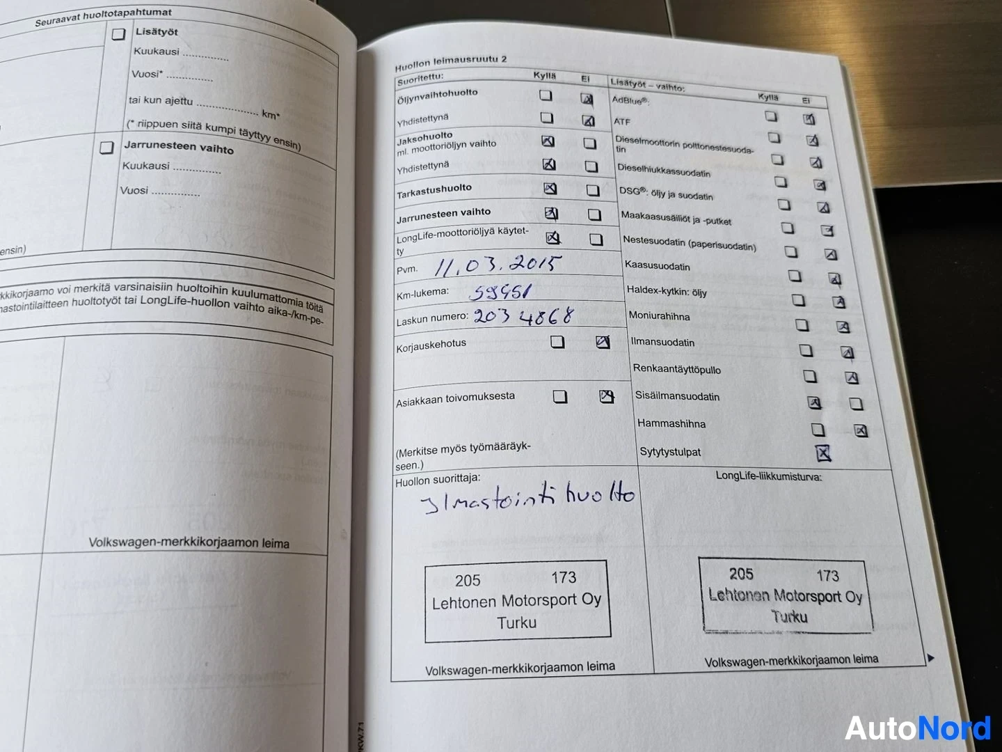 Asiakirja: Volkswagen-merkkikorjaamon leimapalvelu kirja, avoinna sivuilla joissa näkyy huoltohistoria, käsinkirjoitettuja merkintöjä, päivämäärä 11.03.2015, kilometriluke