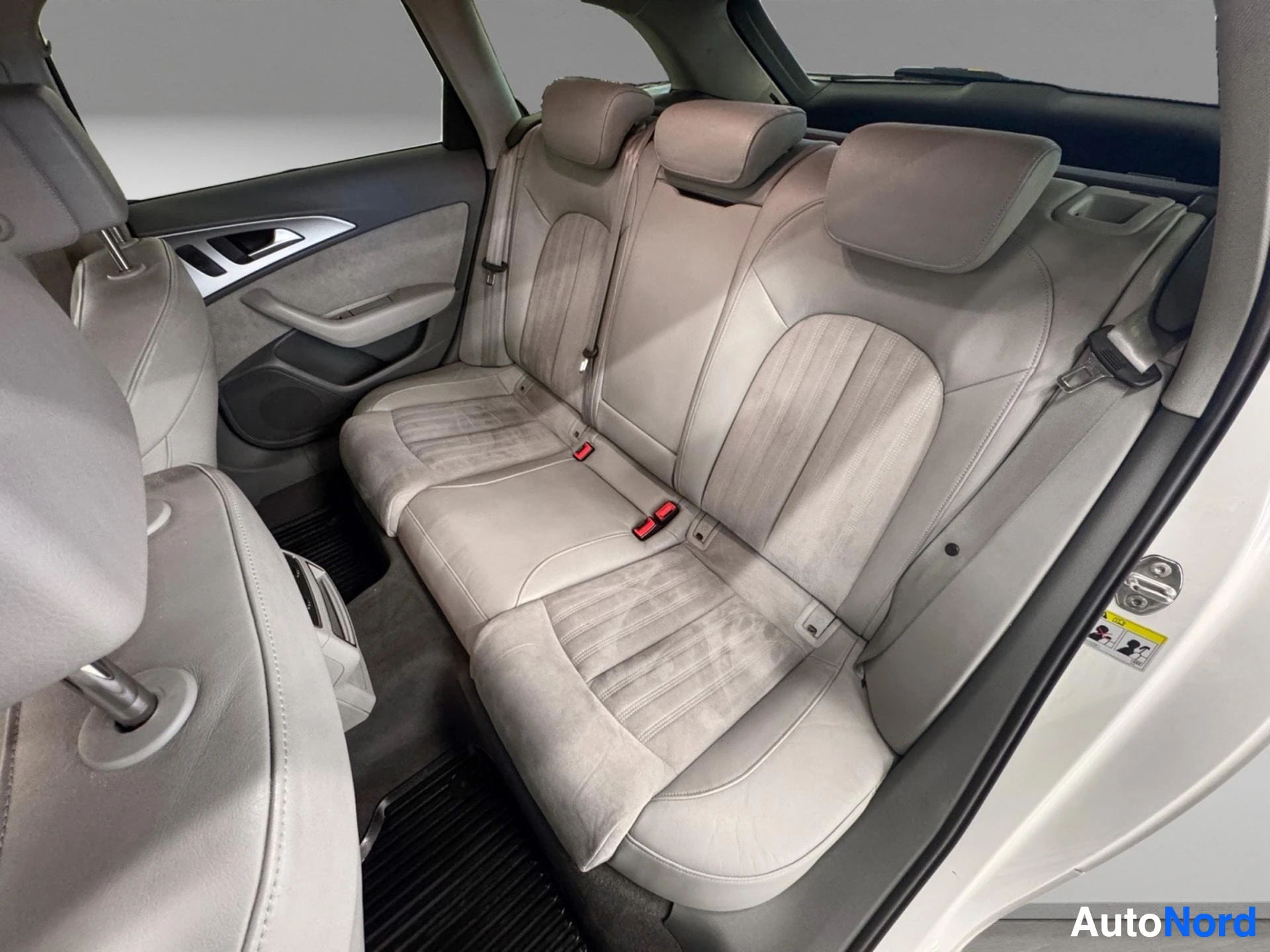 Rear seats with beige leather upholstery and headrests visible