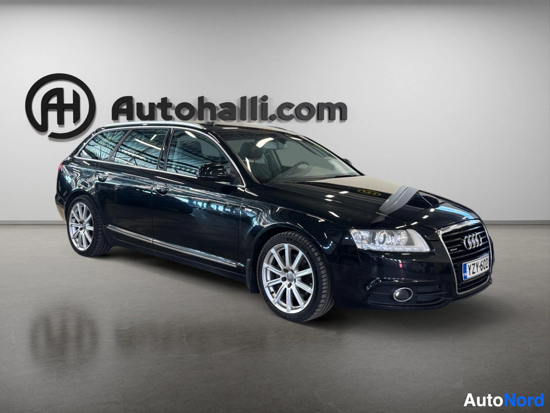 Musta Audi A6 Avant kolmen neljäsosan näkymässä oikealle