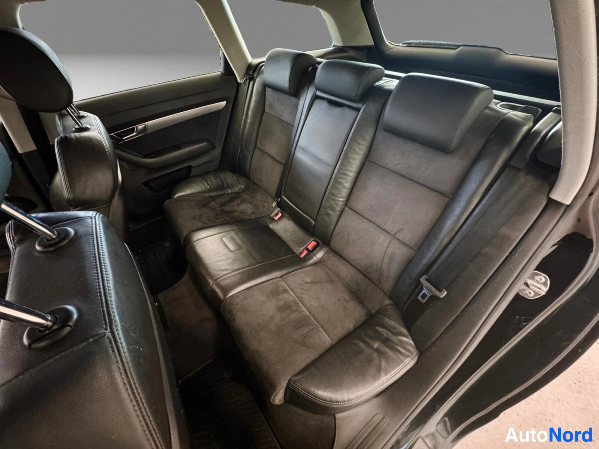 Rear passenger seating area with leather upholstery and side windows