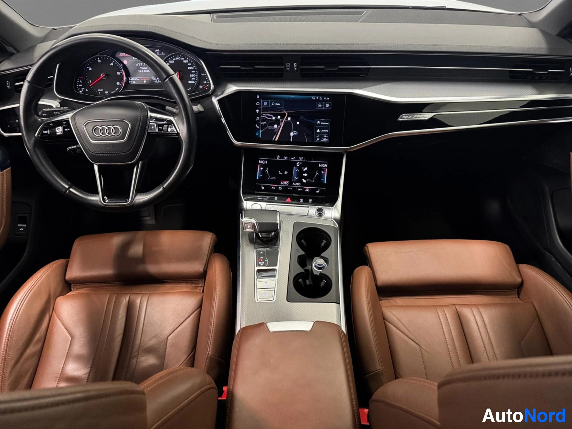 Audi A6 interior dashboard view with brown leather seats and infotainment display