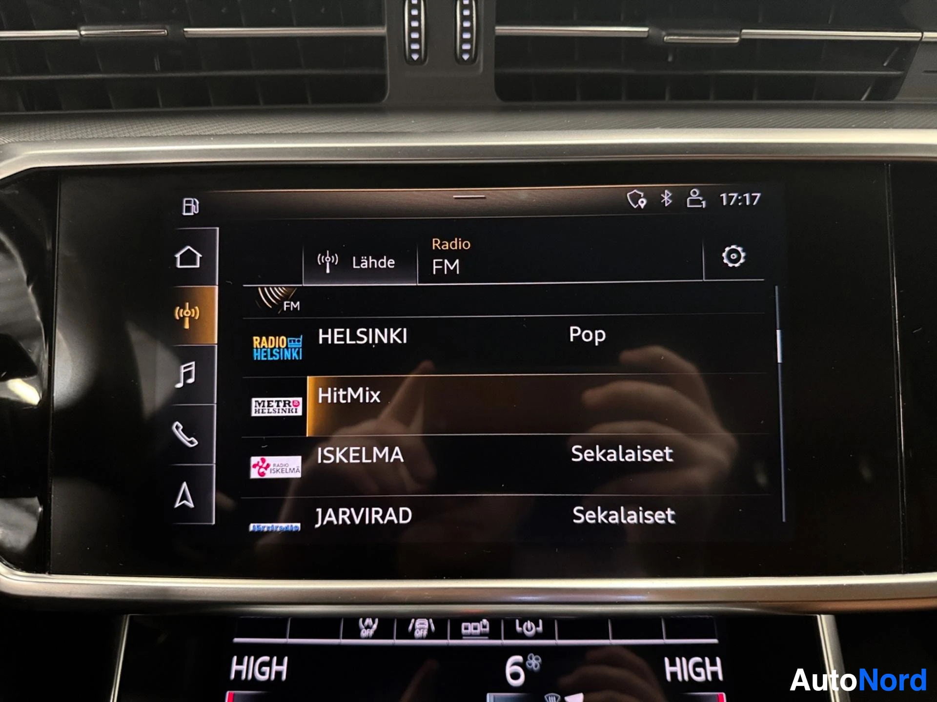 Infotainment screen displaying FM radio stations list.