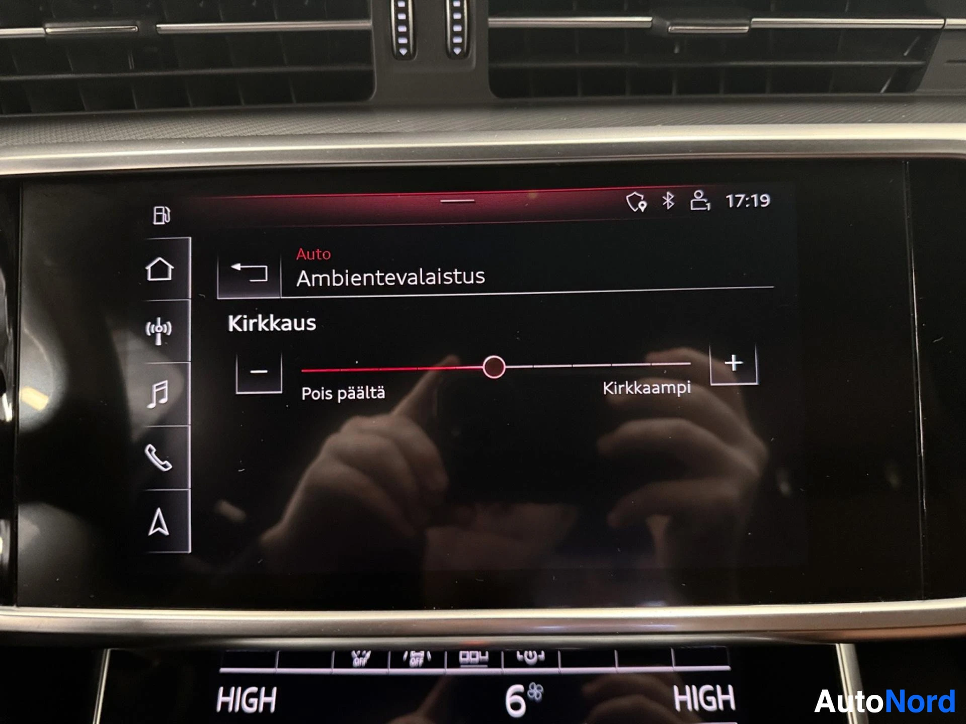 Infotainment display showing ambient lighting brightness control menu