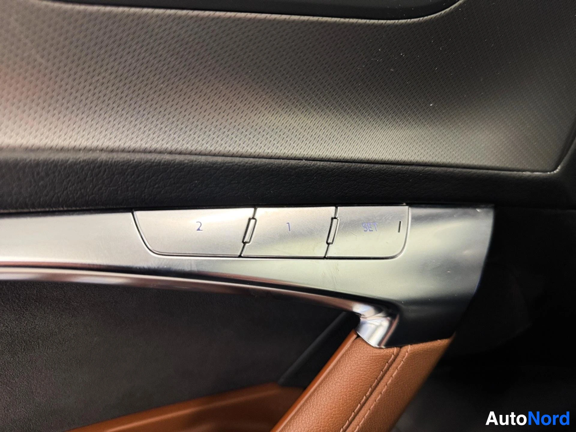 Door trim with window controls and metal accent panel