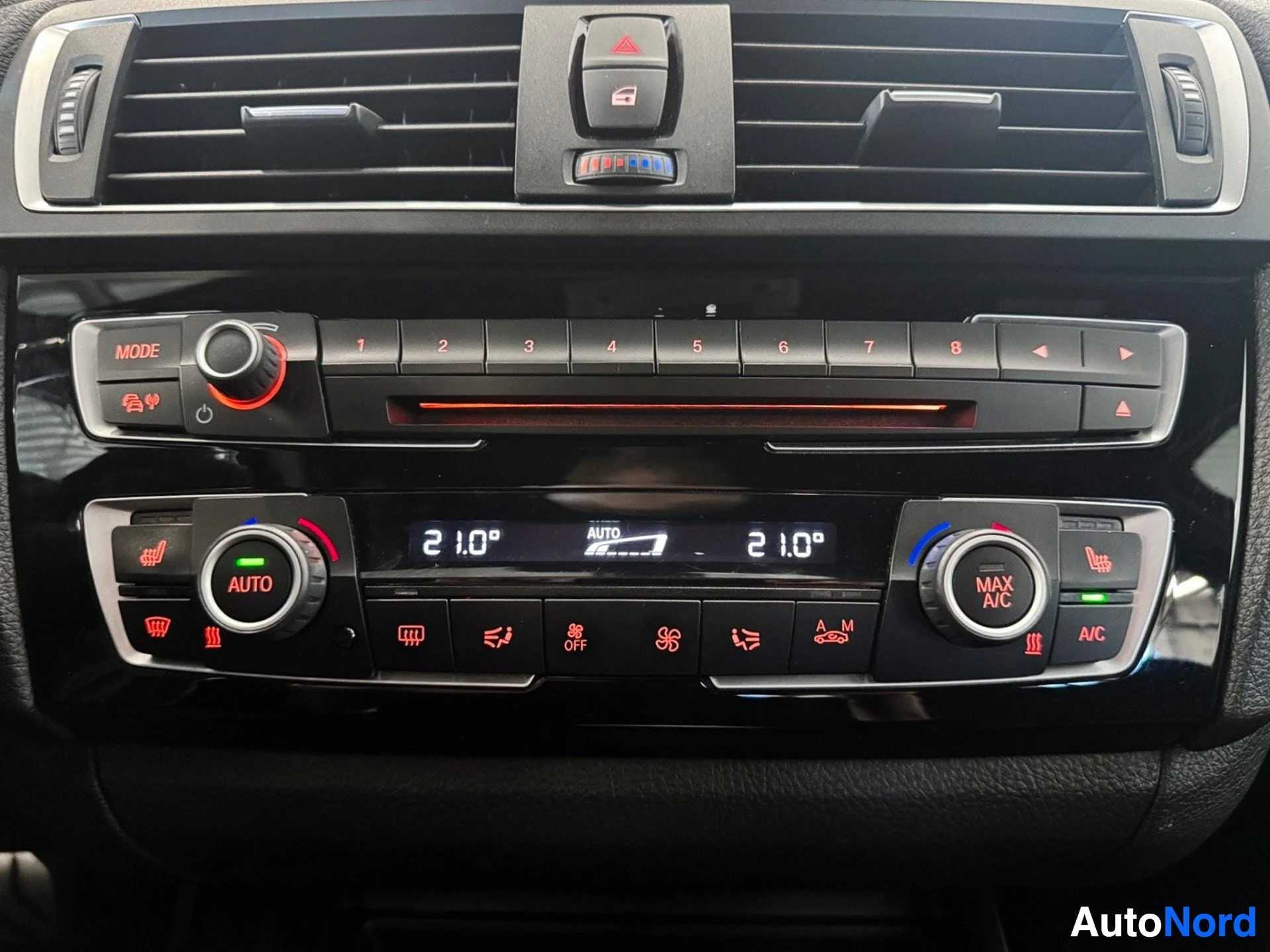 Dashboard controls showing radio, climate control, and air conditioning panel.