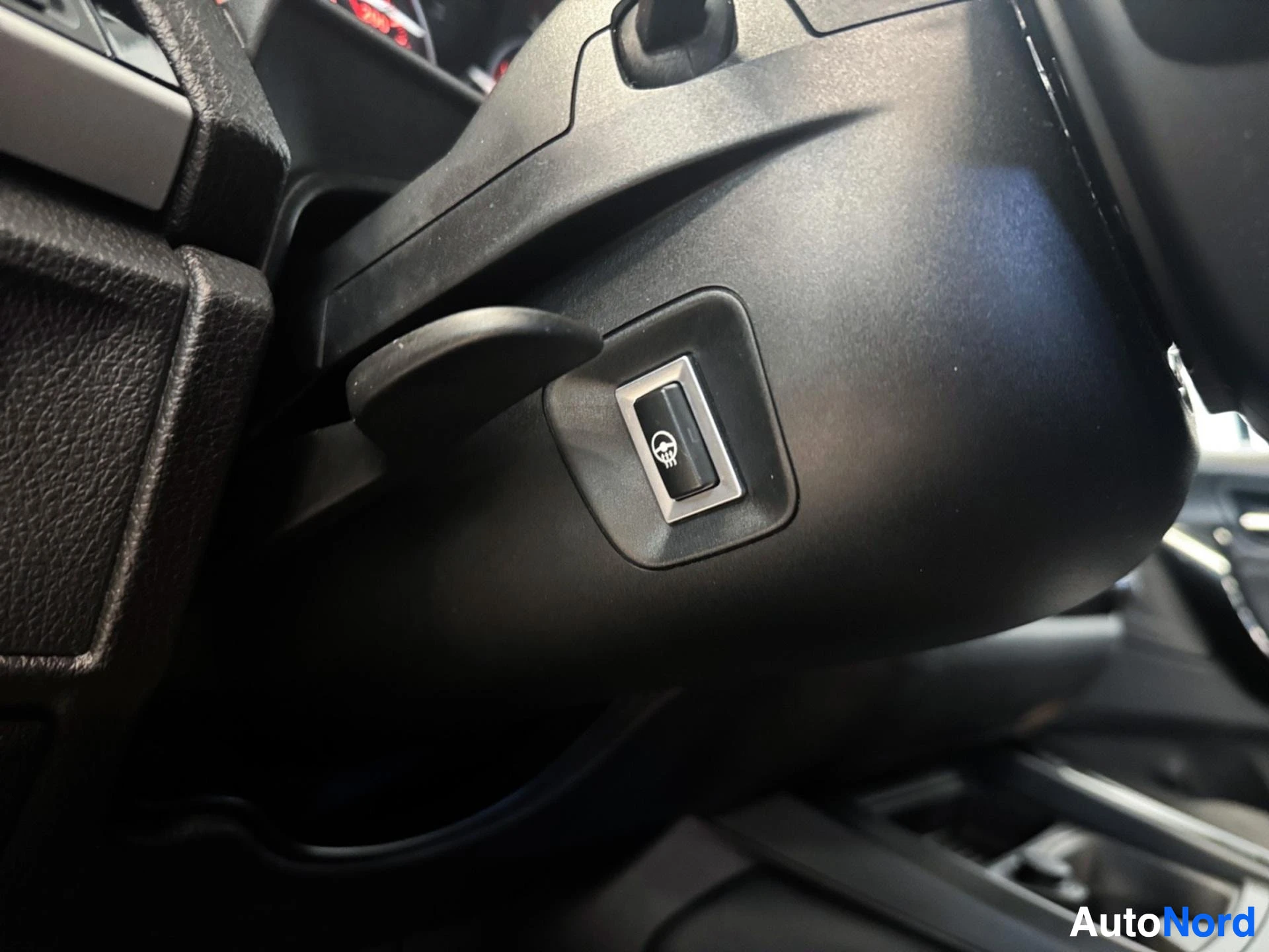 Steering wheel airbag cover detail with BMW emblem visible