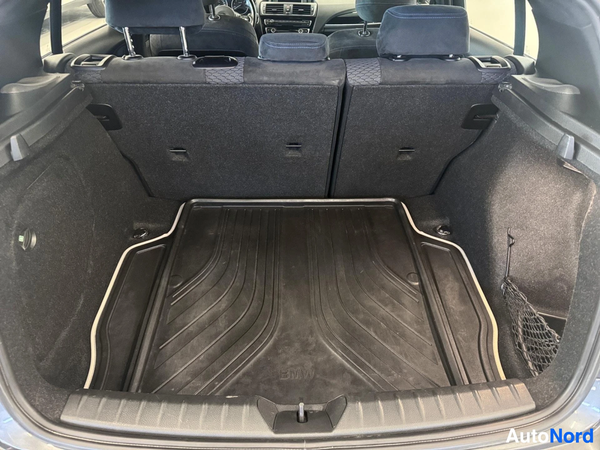 Open boot showing cargo area with rubber mat and folded seats