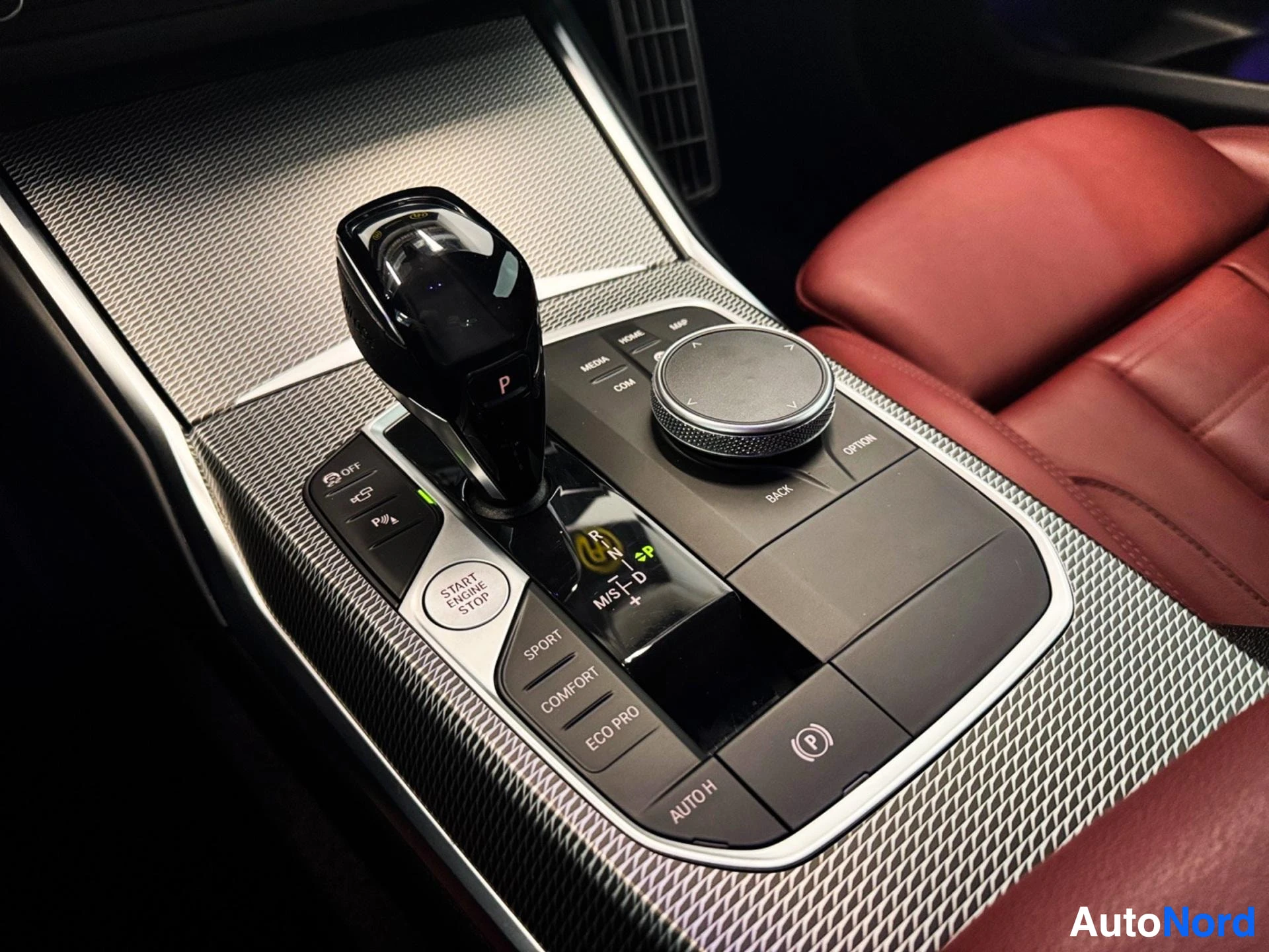Center console with gear shift, iDrive controller, and mode selection buttons