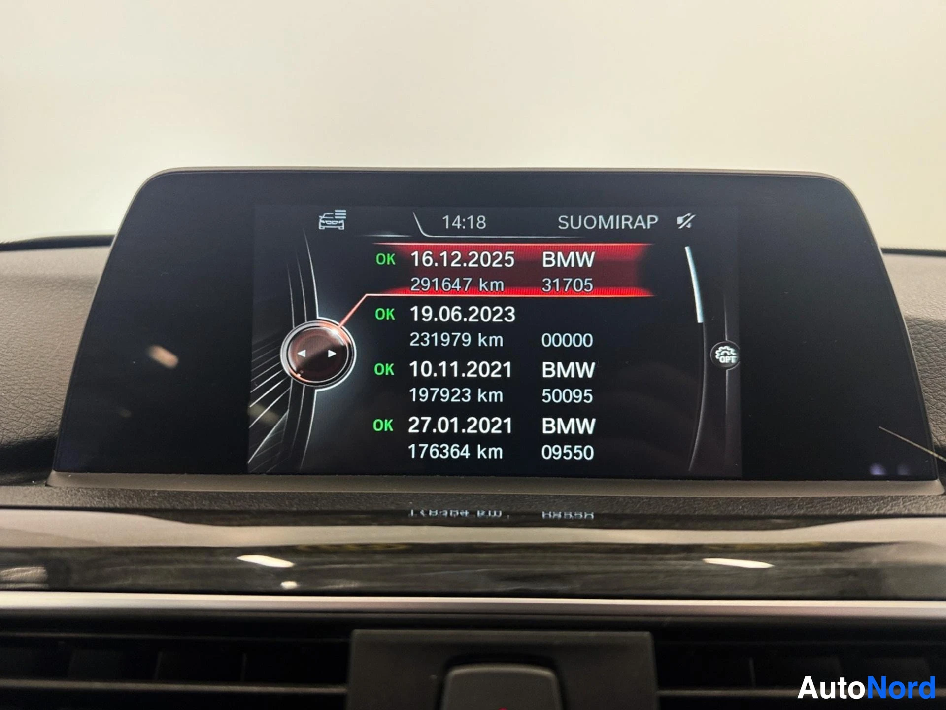 Infotainment display showing vehicle service history with inspection dates and mileage