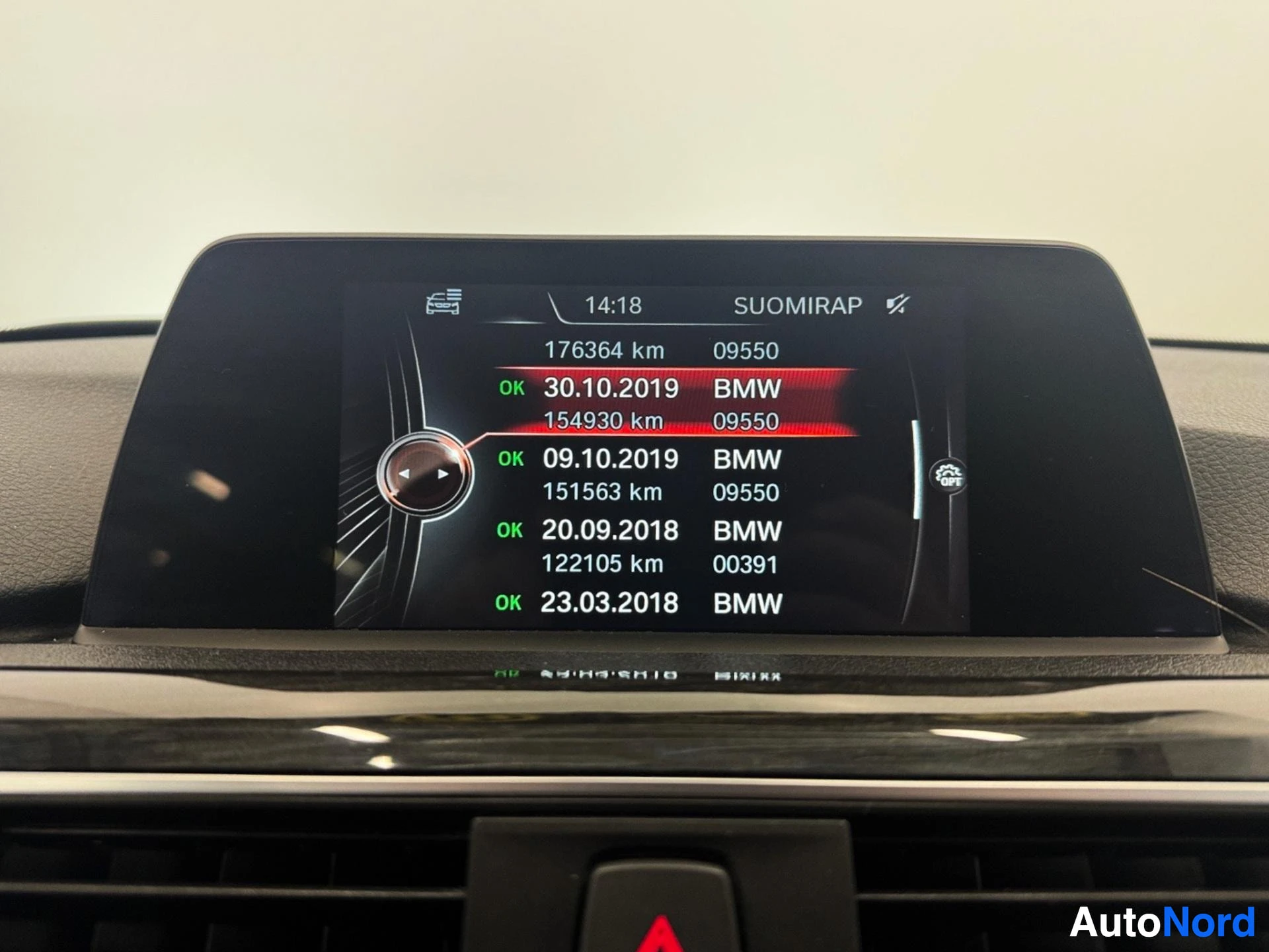 Infotainment screen showing service history records with kilometers and dates
