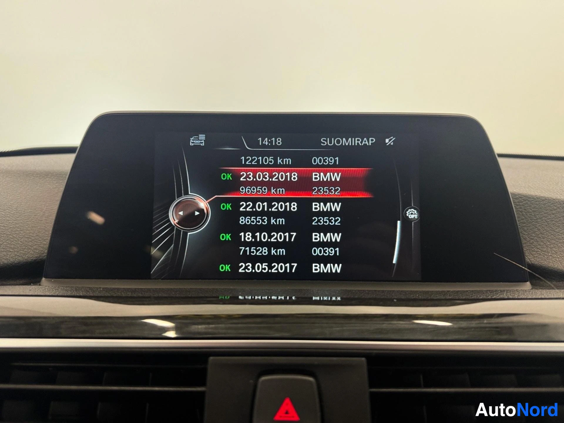 Infotainment screen showing service history records with kilometers and dates