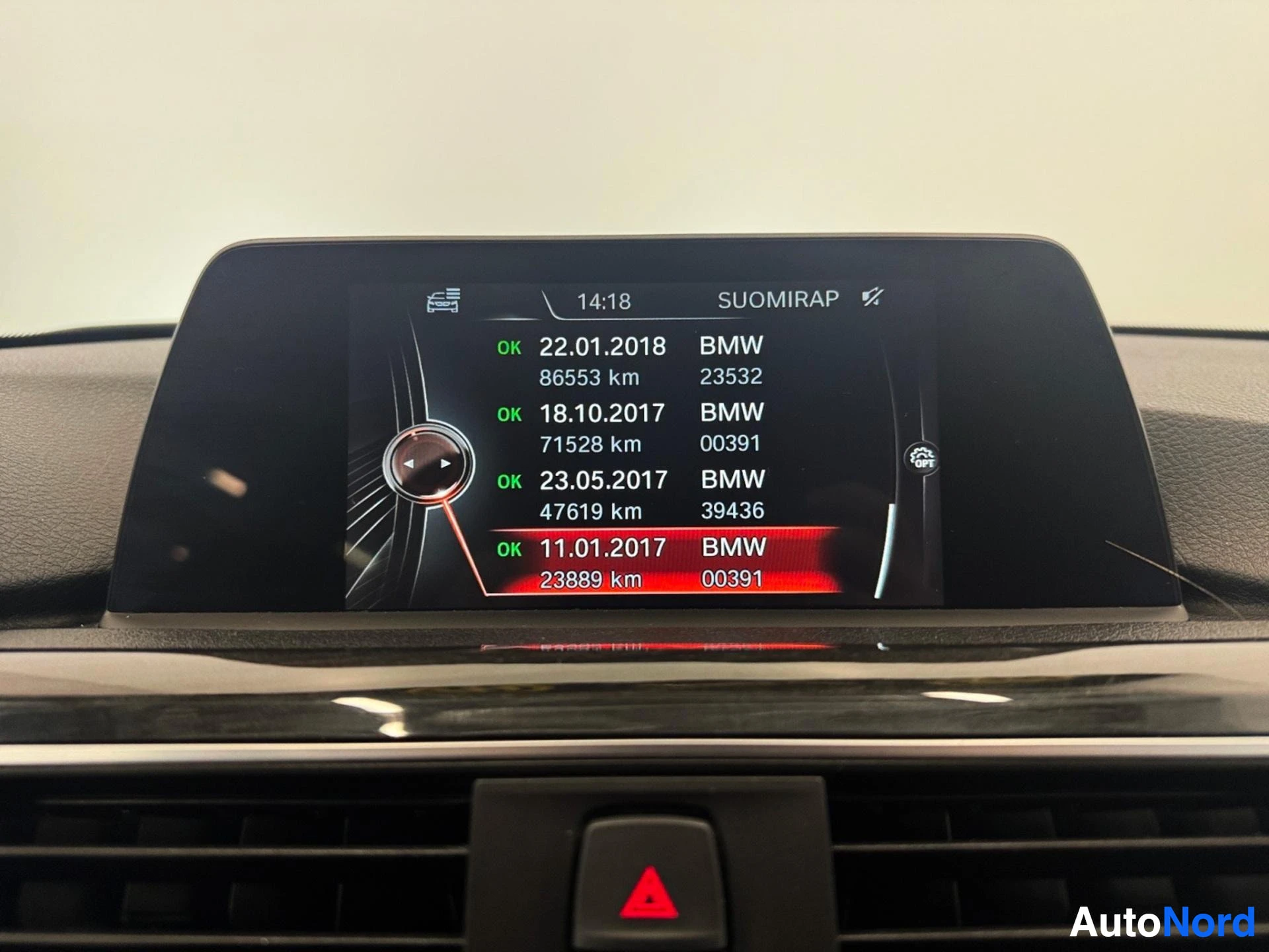Infotainment screen showing service history records with kilometers and dates