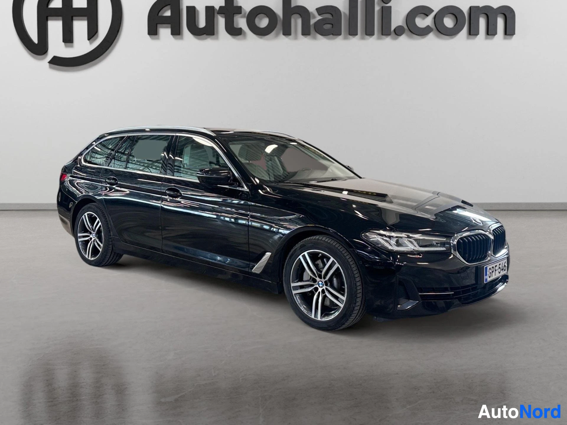 Black BMW Touring estate car displayed from front three-quarter angle