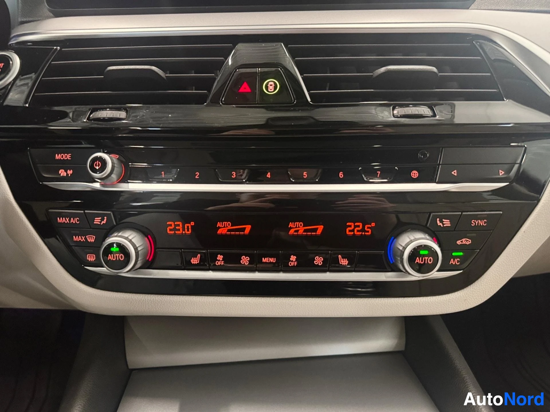 Climate control panel with dual-zone automatic temperature settings and radio controls.
