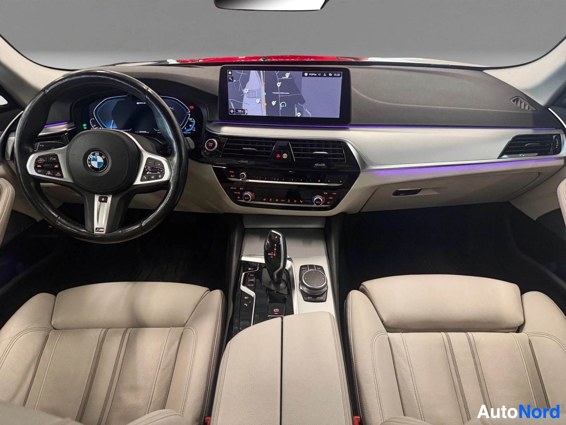 Full dashboard view with steering wheel and infotainment screen
