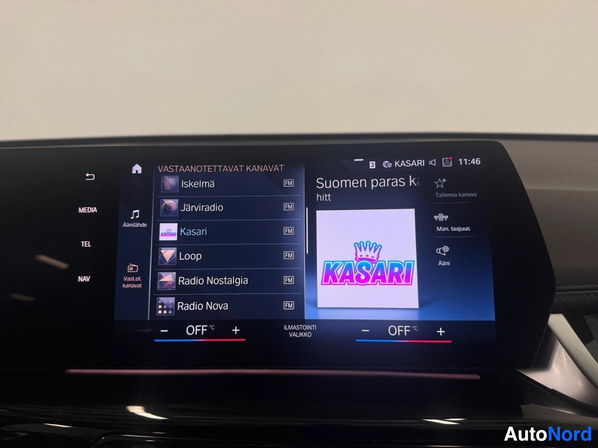 Infotainment system displaying radio stations and Kasari logo on screen