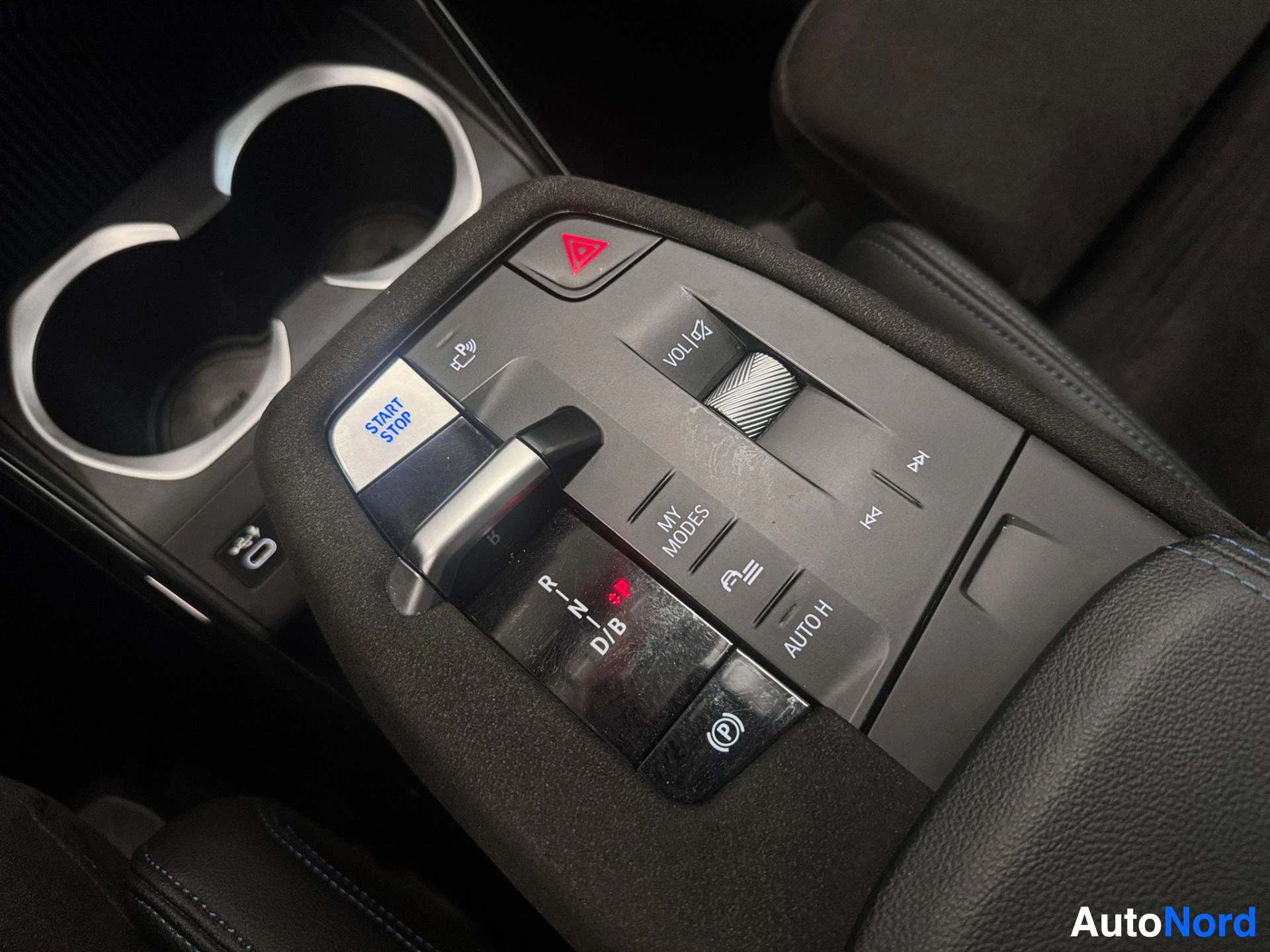 Center console controls including start/stop button and climate settings