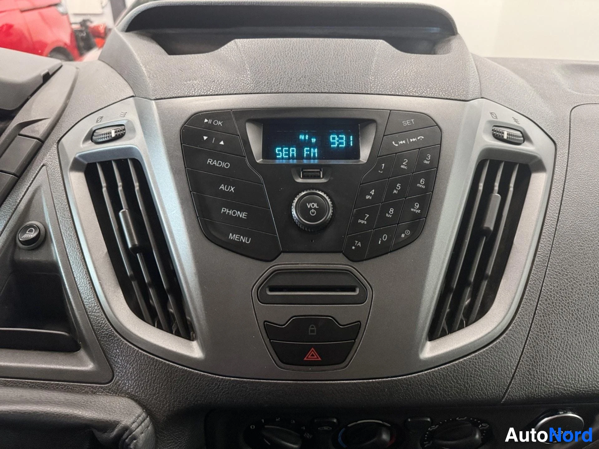 Dashboard with radio display showing 93.1 FM and climate controls