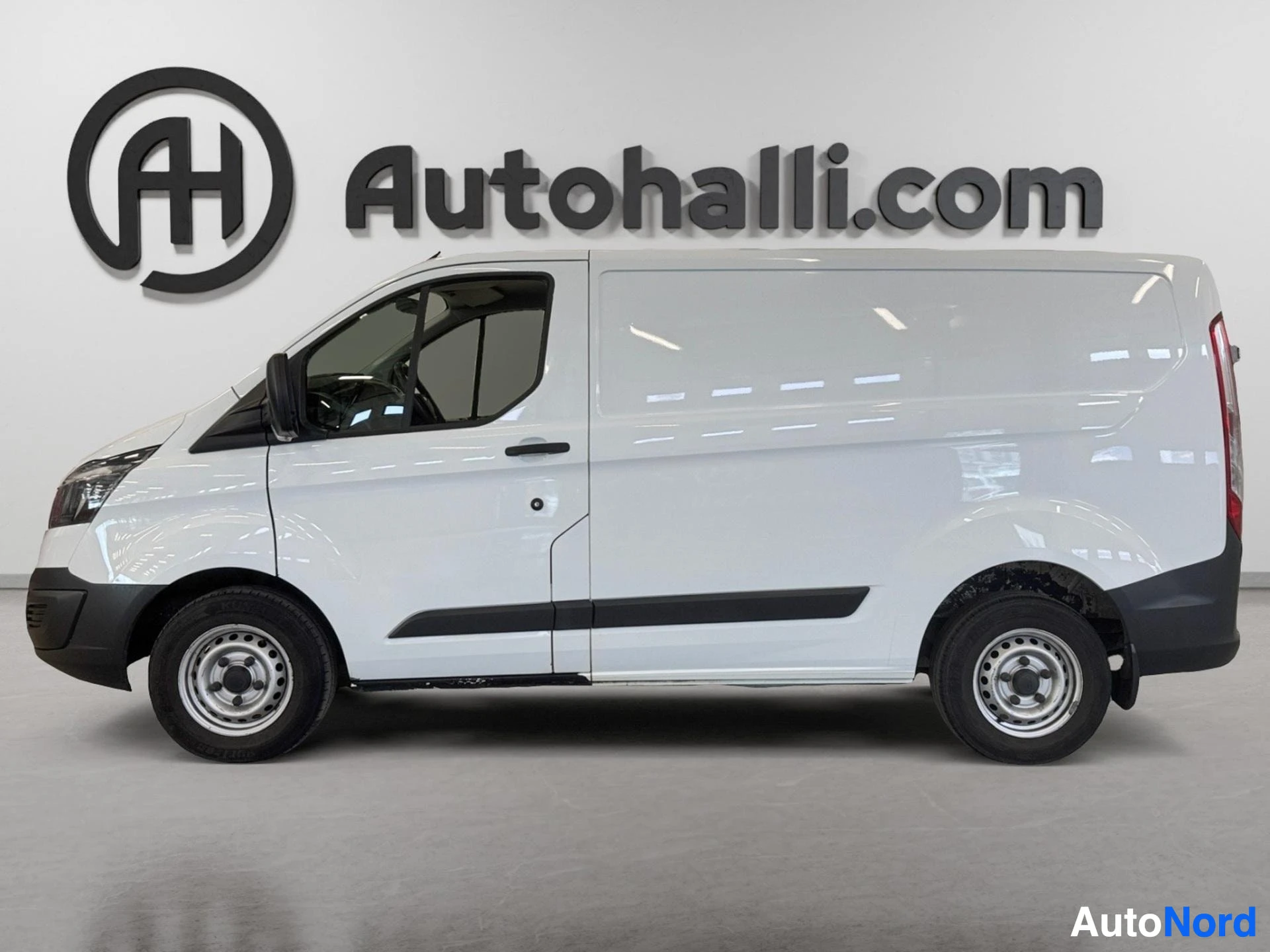 White van shown from side profile with open driver's door