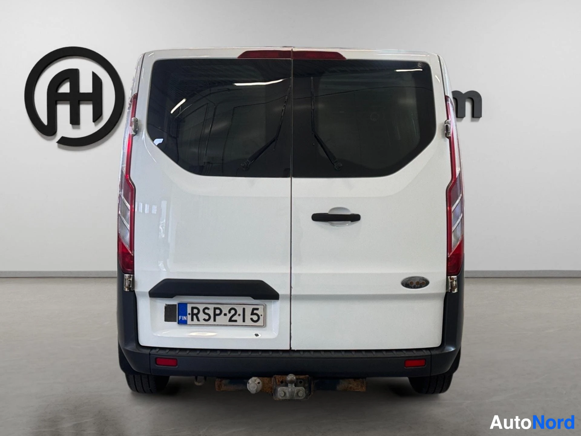 White van rear view showing closed doors and red taillights