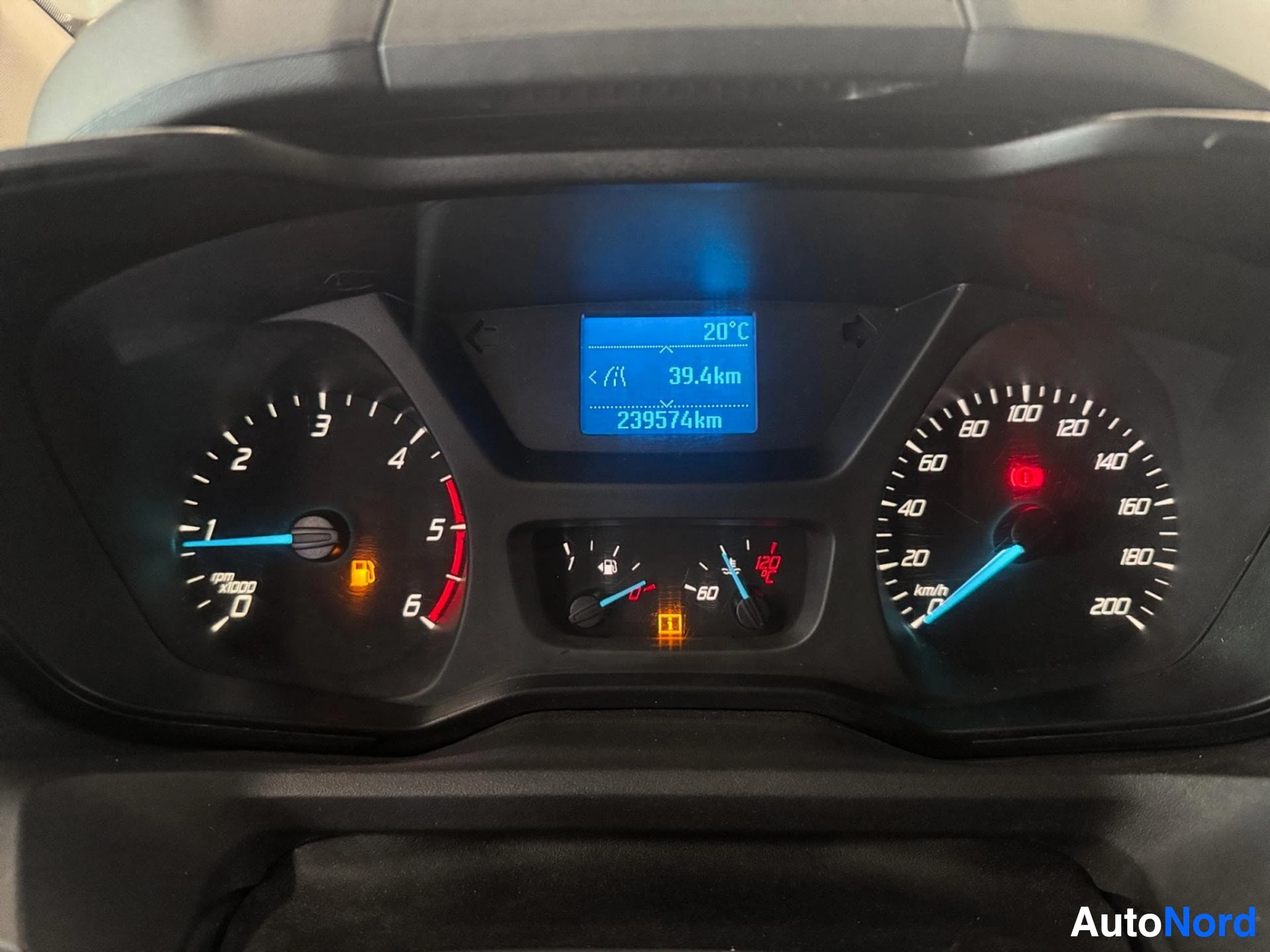 Dashboard instrument cluster displaying temperature, distance and mileage readings