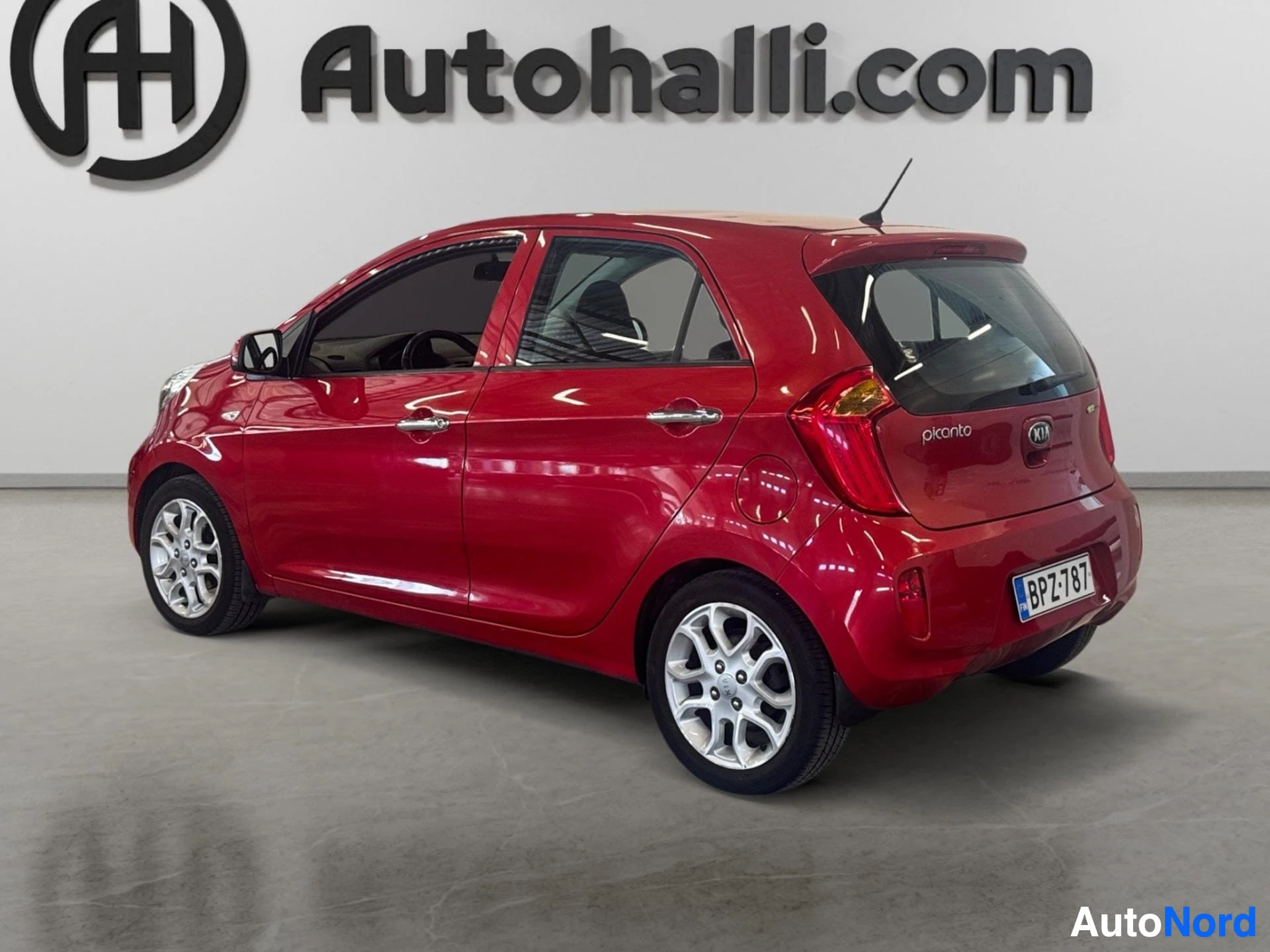 Red Kia Picanto three-quarter front view with doors open