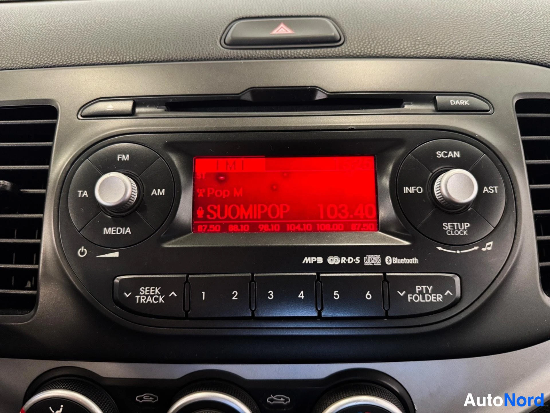 Dashboard infotainment system with red display, radio and media controls