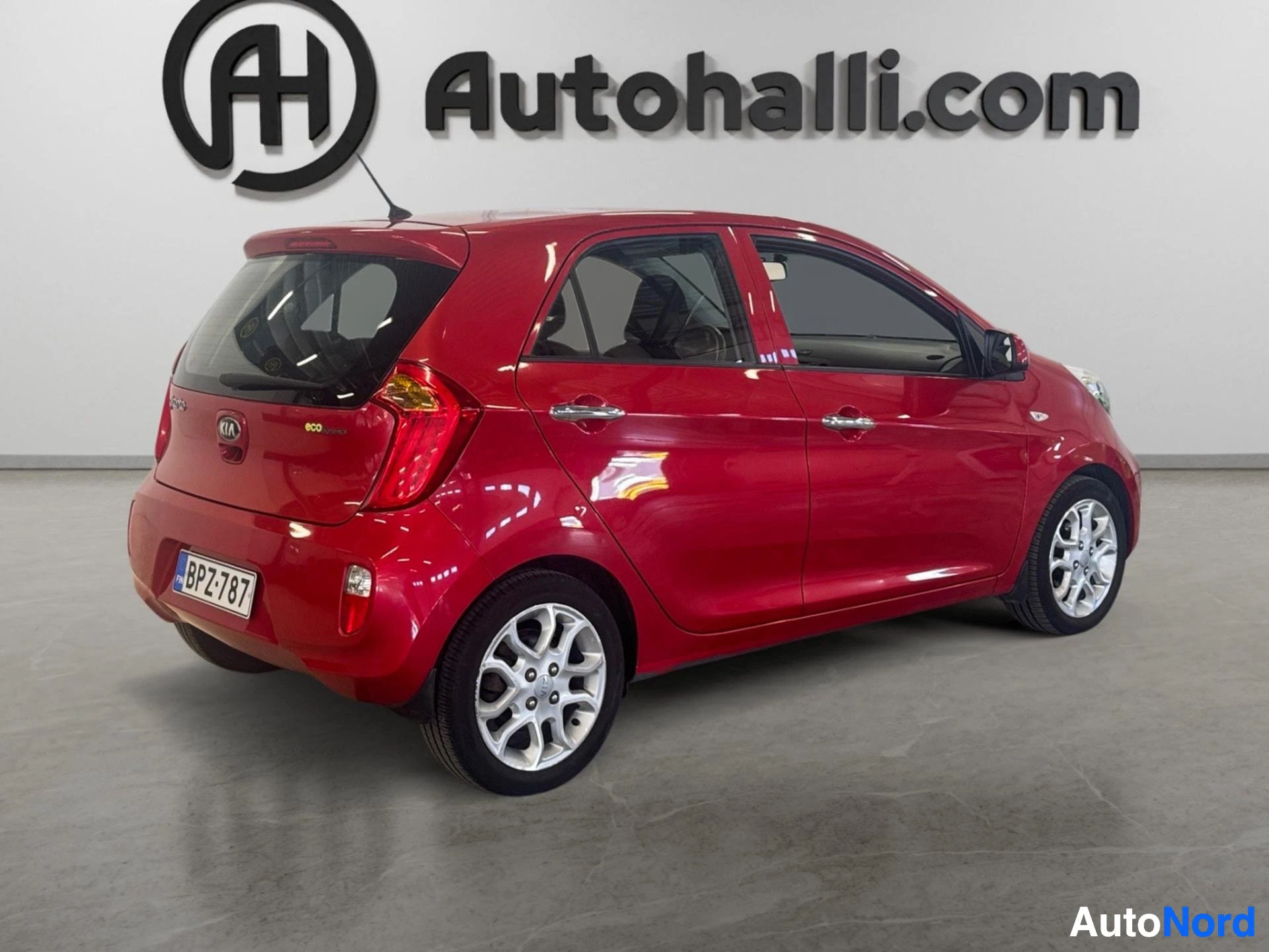 Red Kia Picanto rear three-quarter view showing hatchback design