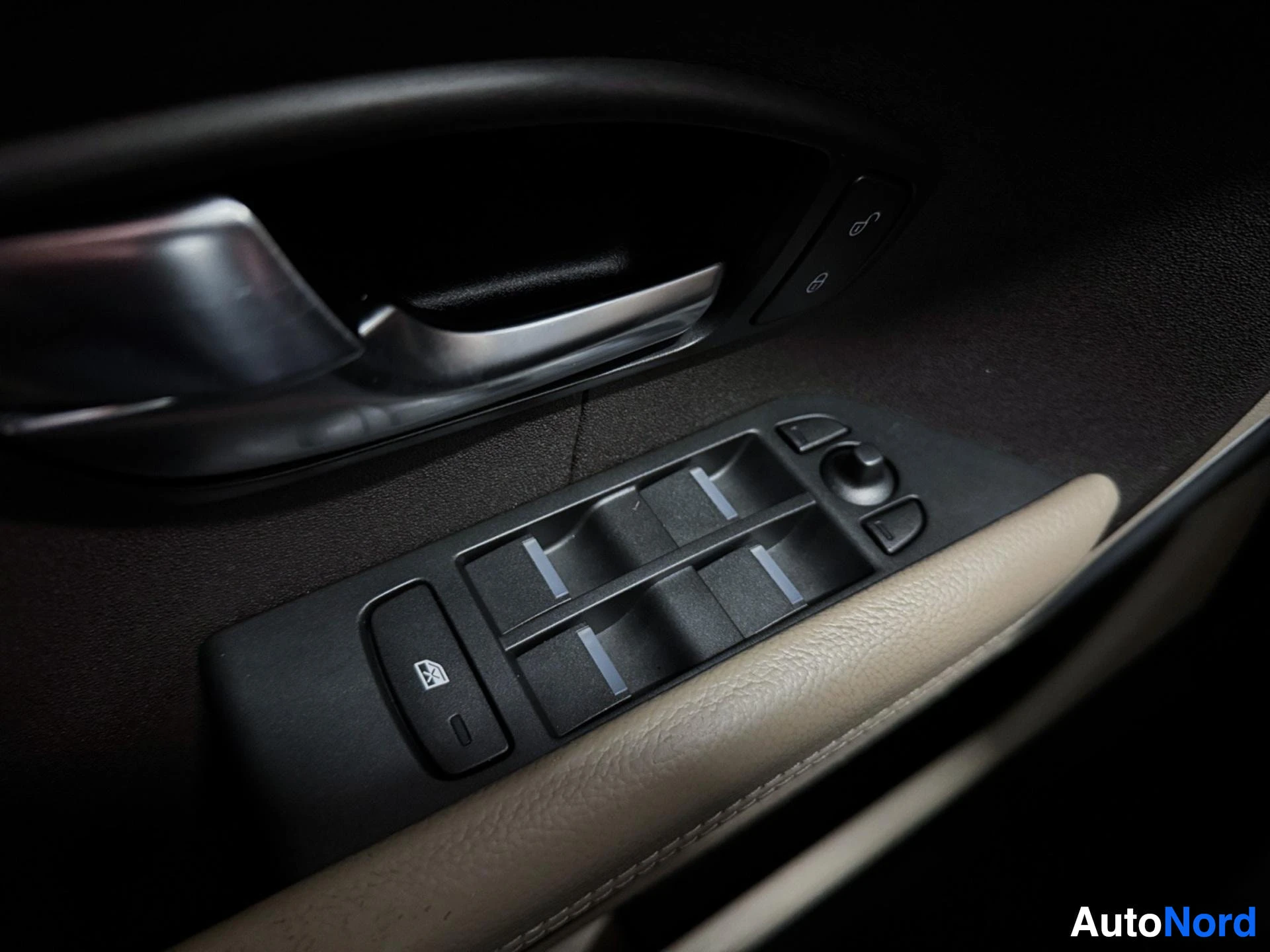 Driver side door panel with window and seat control buttons