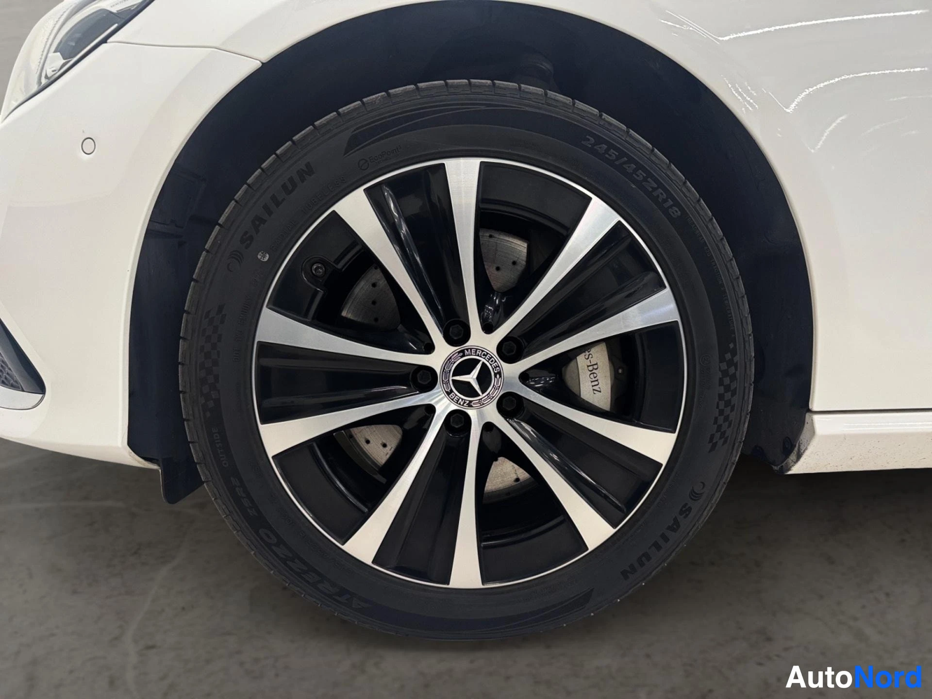 White Mercedes-Benz wheel with black and white alloy rim and Michelin tire