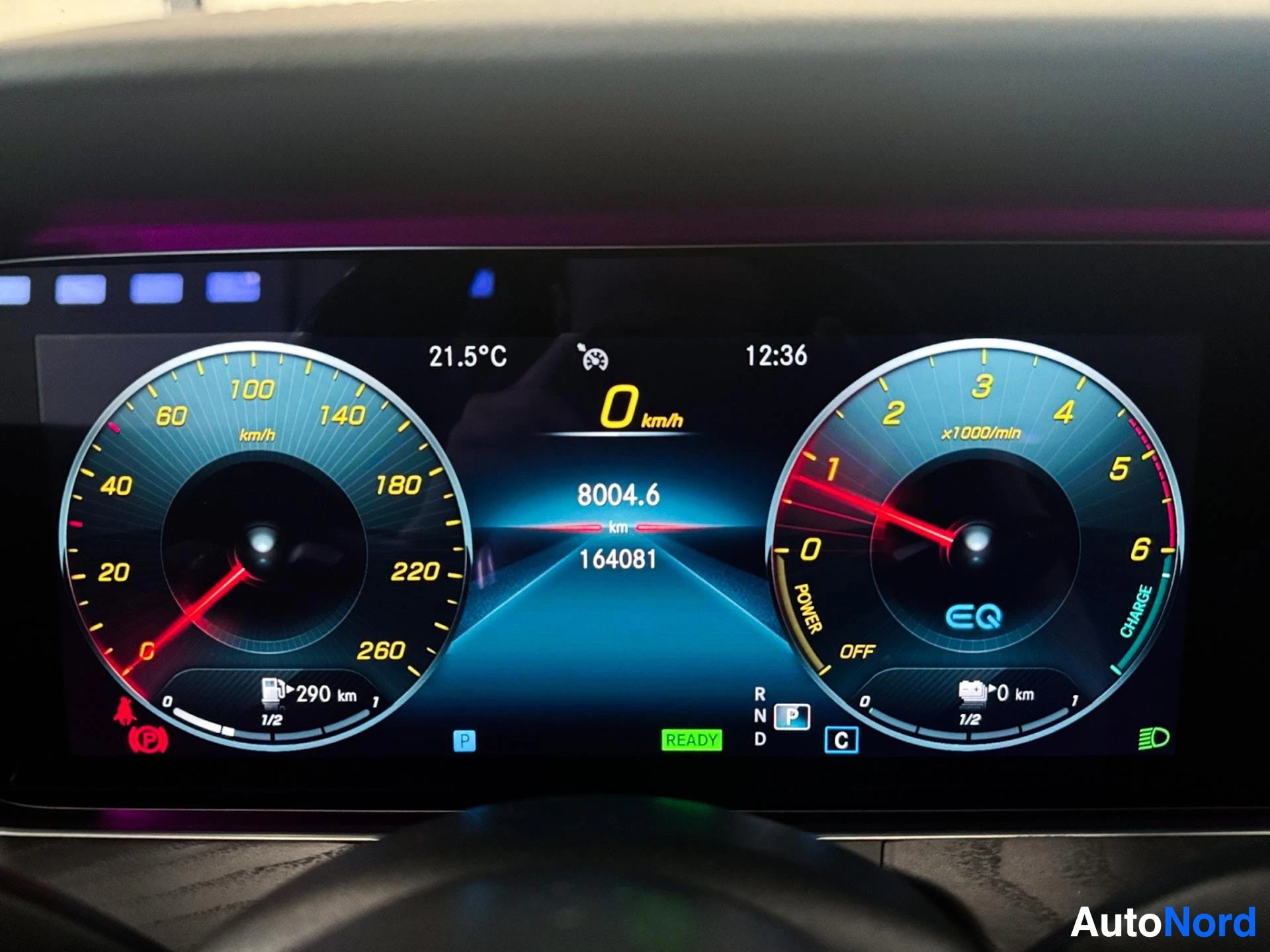 Digital instrument cluster displaying speedometer, tachometer, and trip information