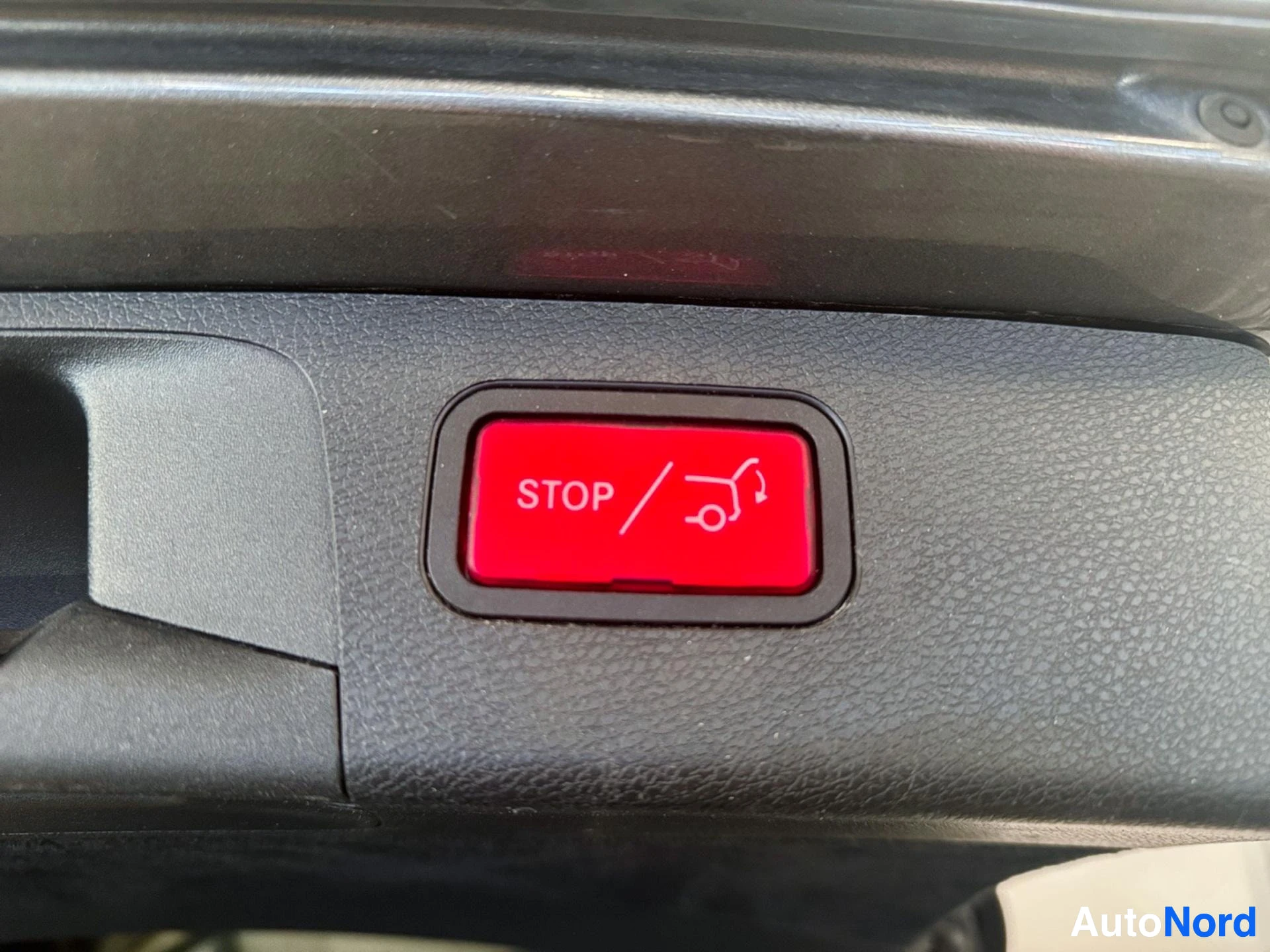 Red interior stop and engine button on dashboard panel