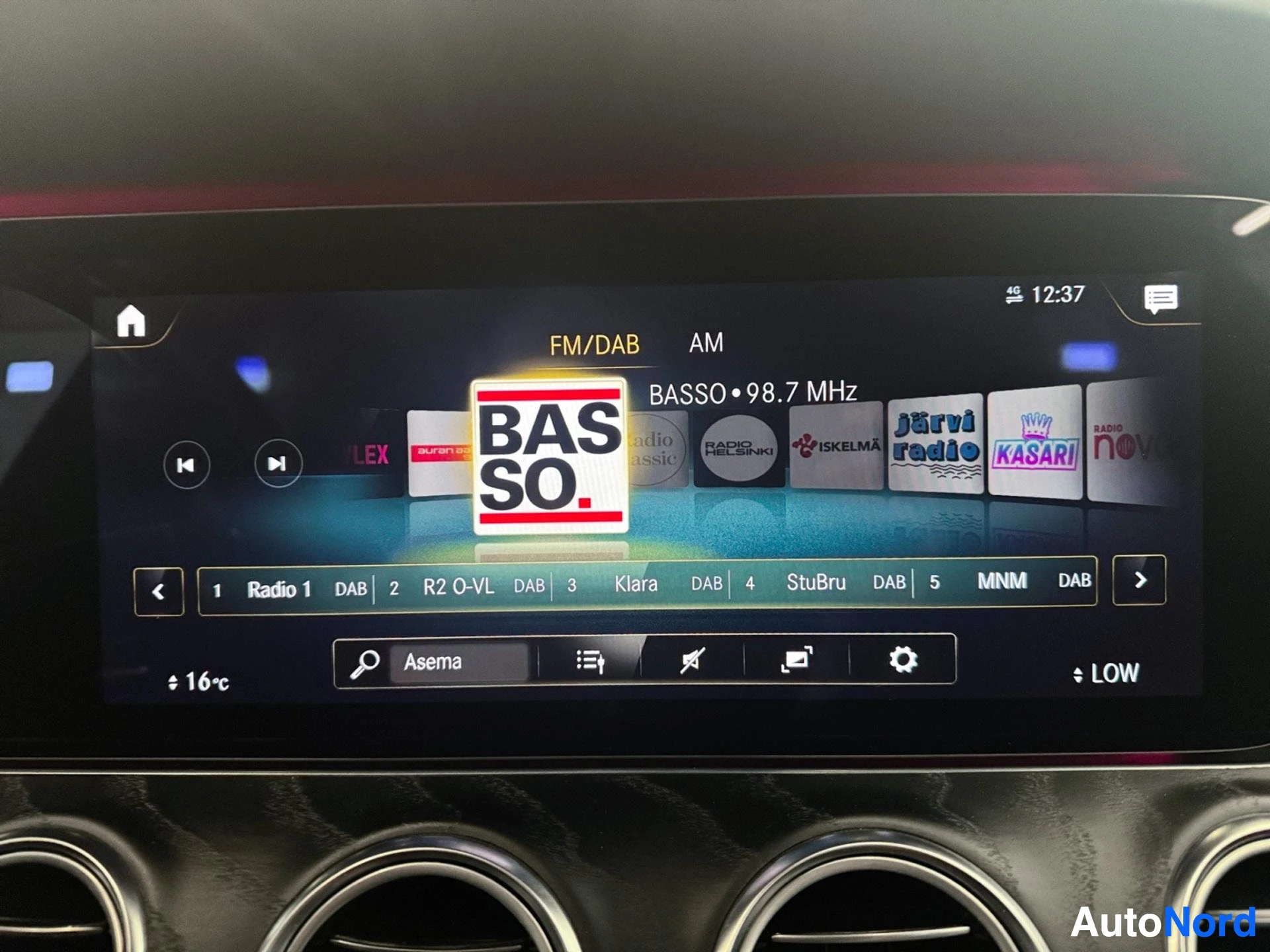 Radio tuner interface displaying FM/DAB stations on widescreen display