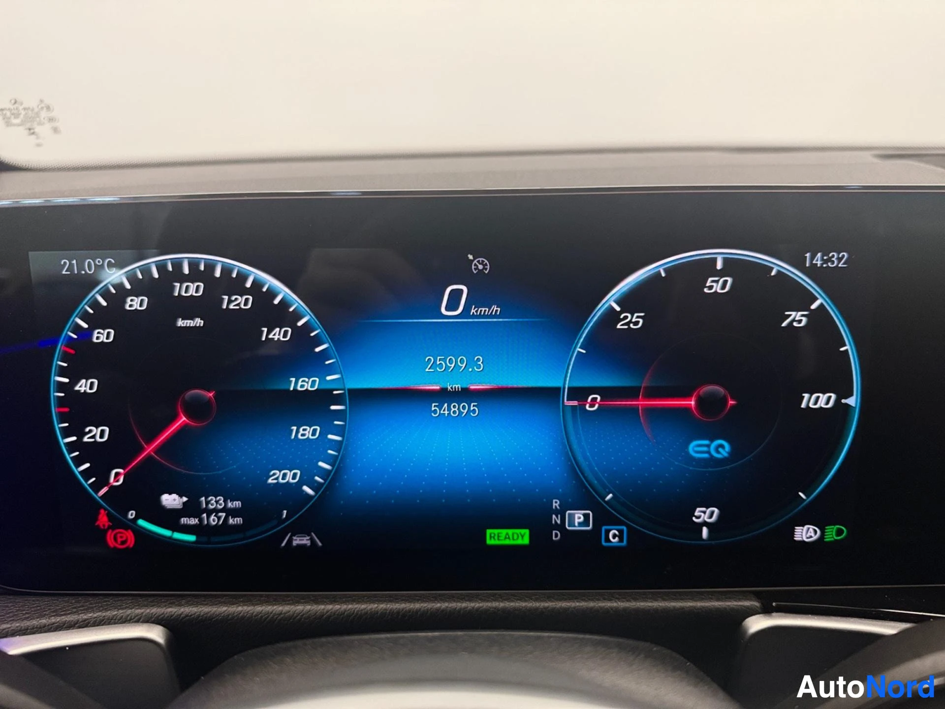 Digital instrument cluster showing speedometer, fuel gauge, and vehicle status indicators.