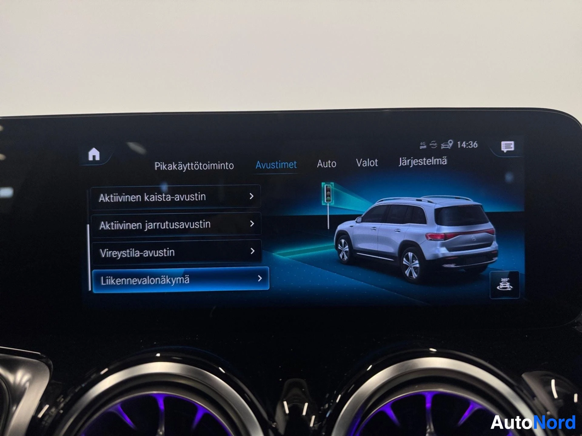 Infotainment screen displaying active driving assistance features with vehicle overhead view