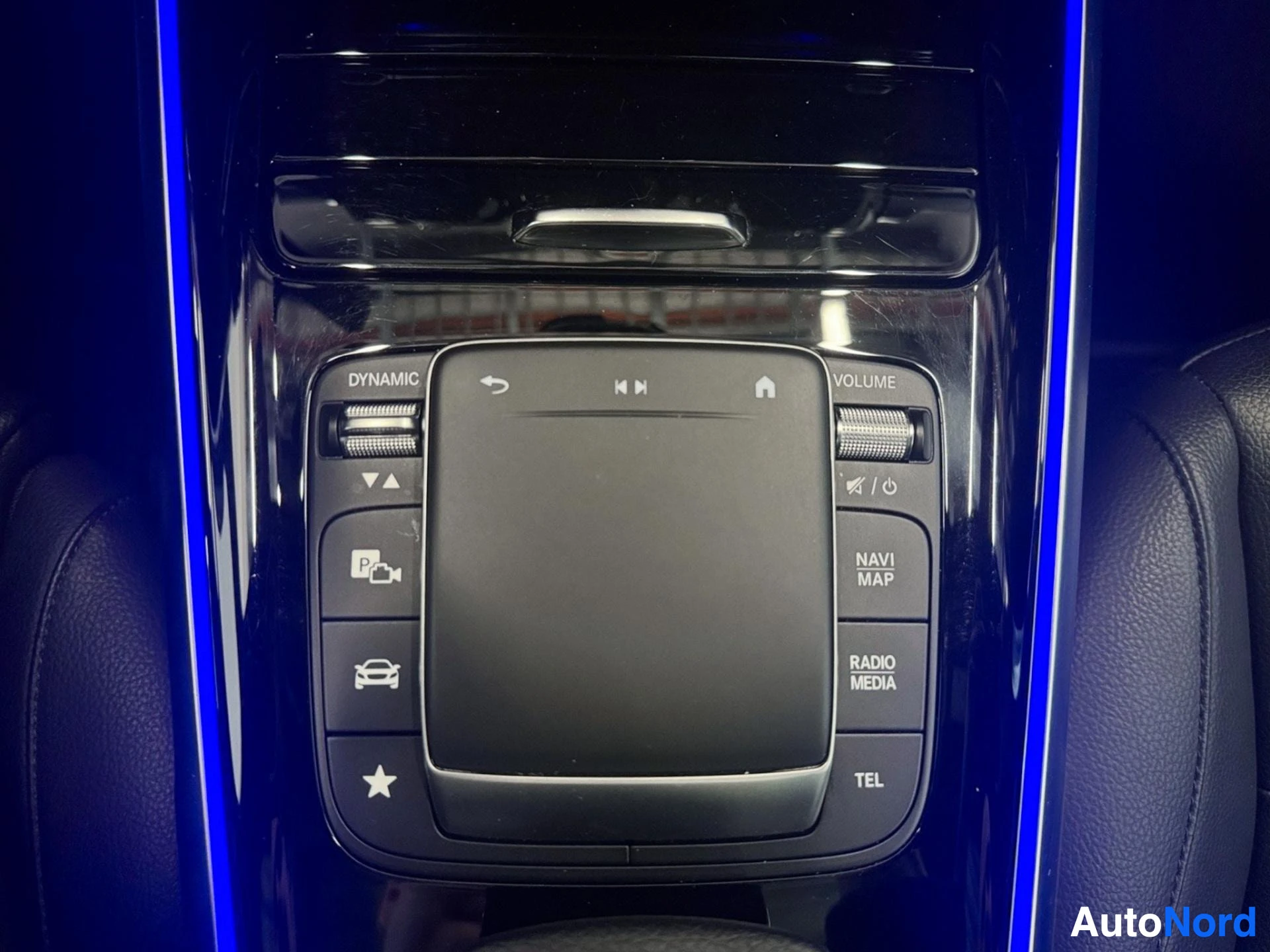 Infotainment system touchscreen with media and navigation controls displayed