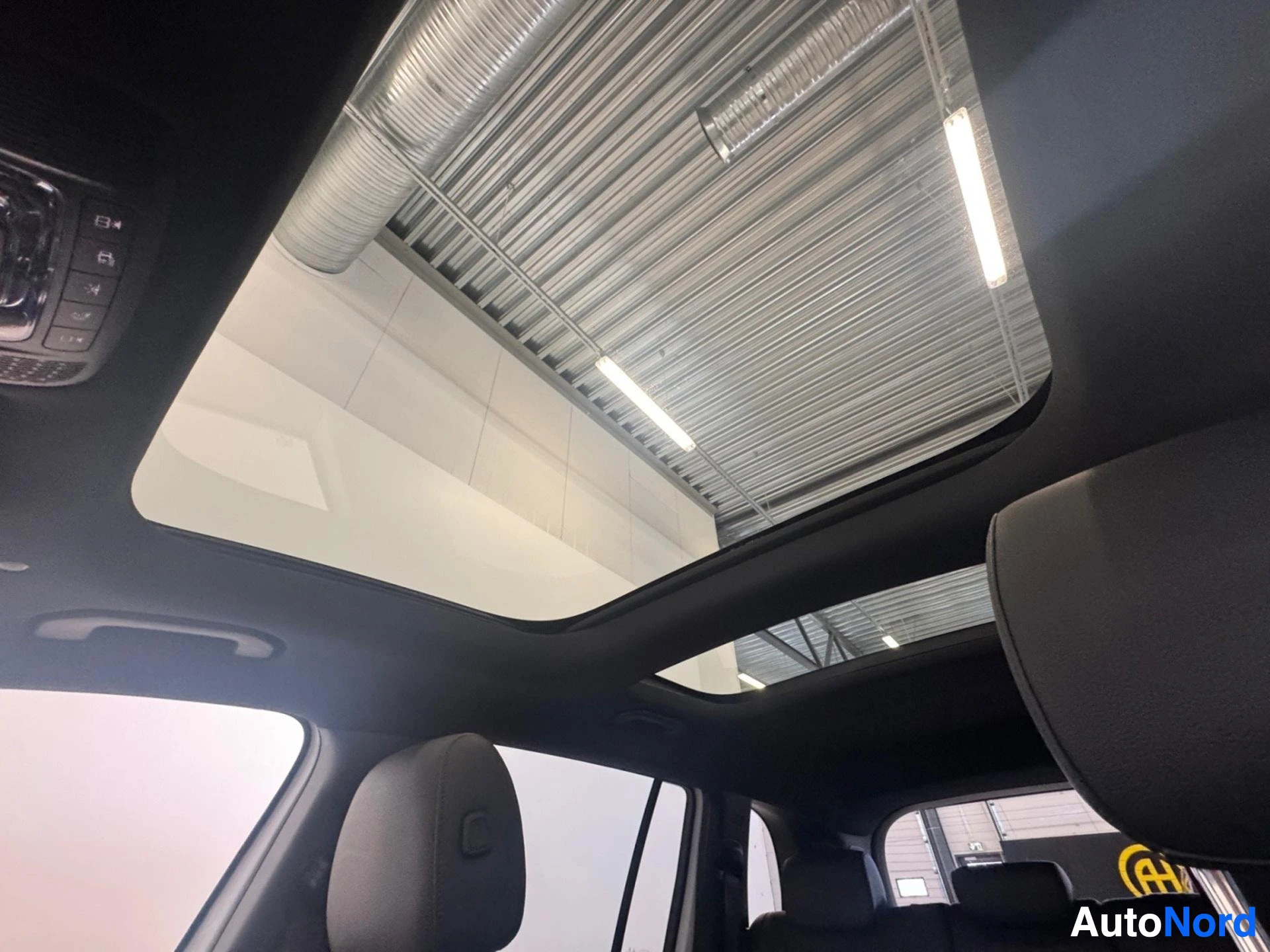 Panoramic sunroof with open position viewed from interior ceiling