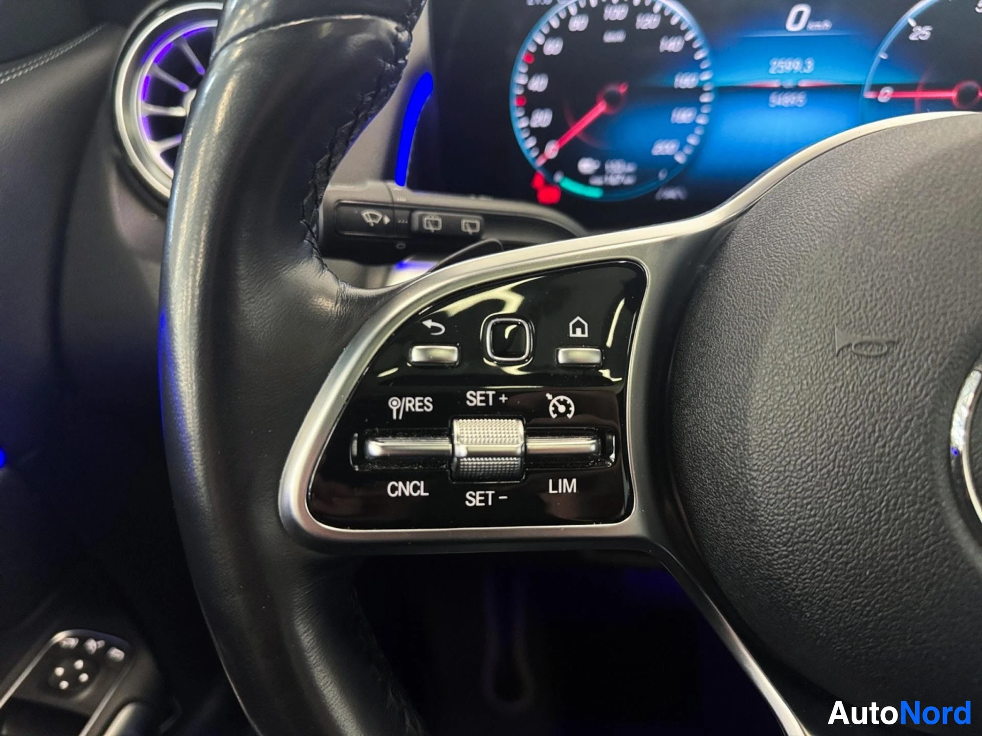 Left steering wheel spoke buttons for cruise control and vehicle settings.