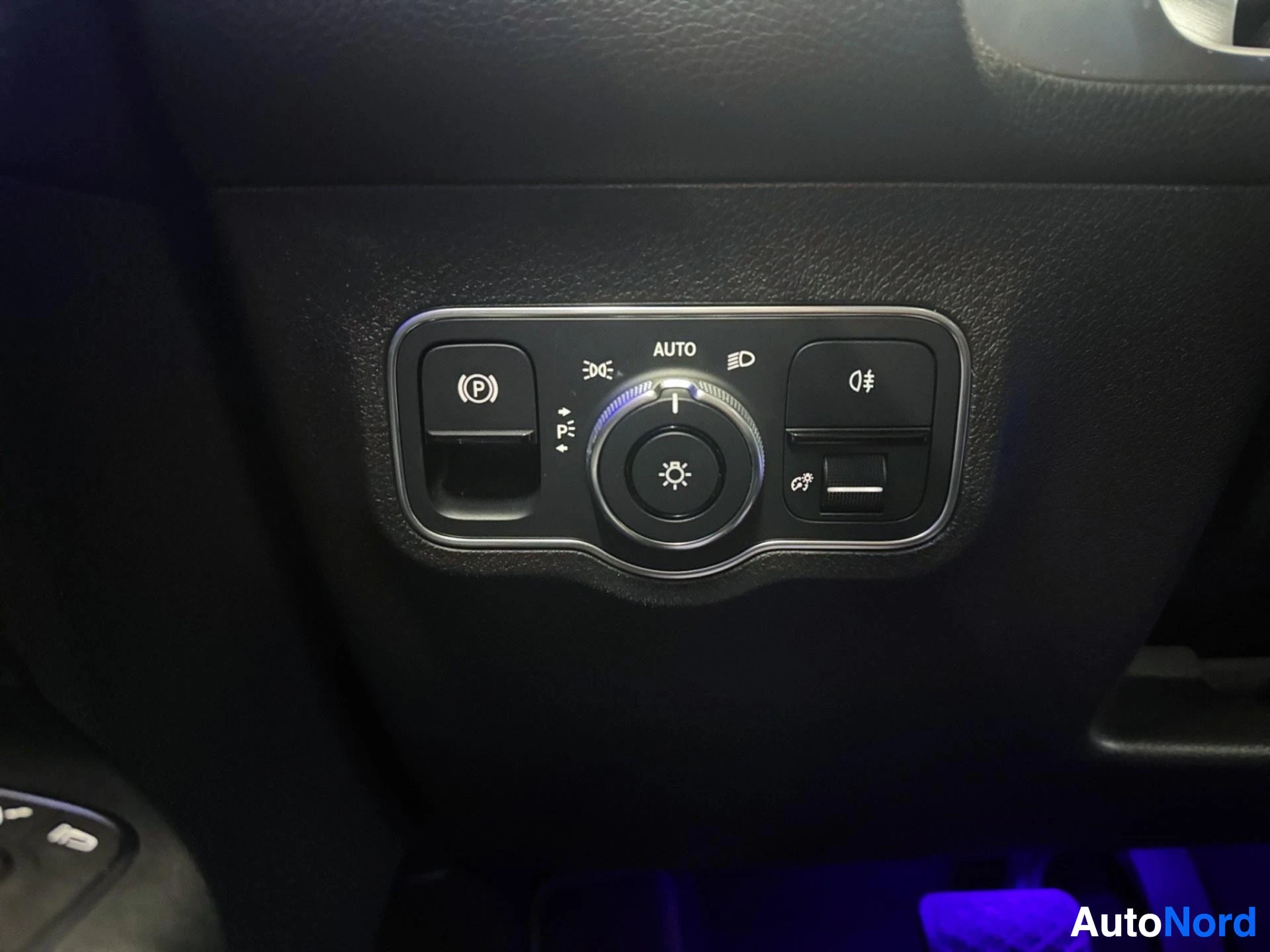 Overhead panel with parking brake, headlight, and climate control buttons