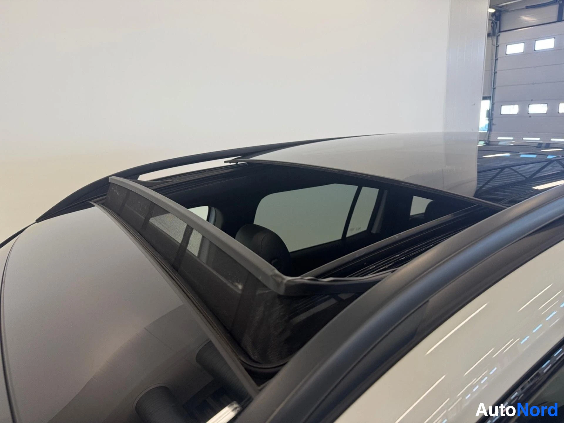Panoramic sunroof opening viewed from above with black frame