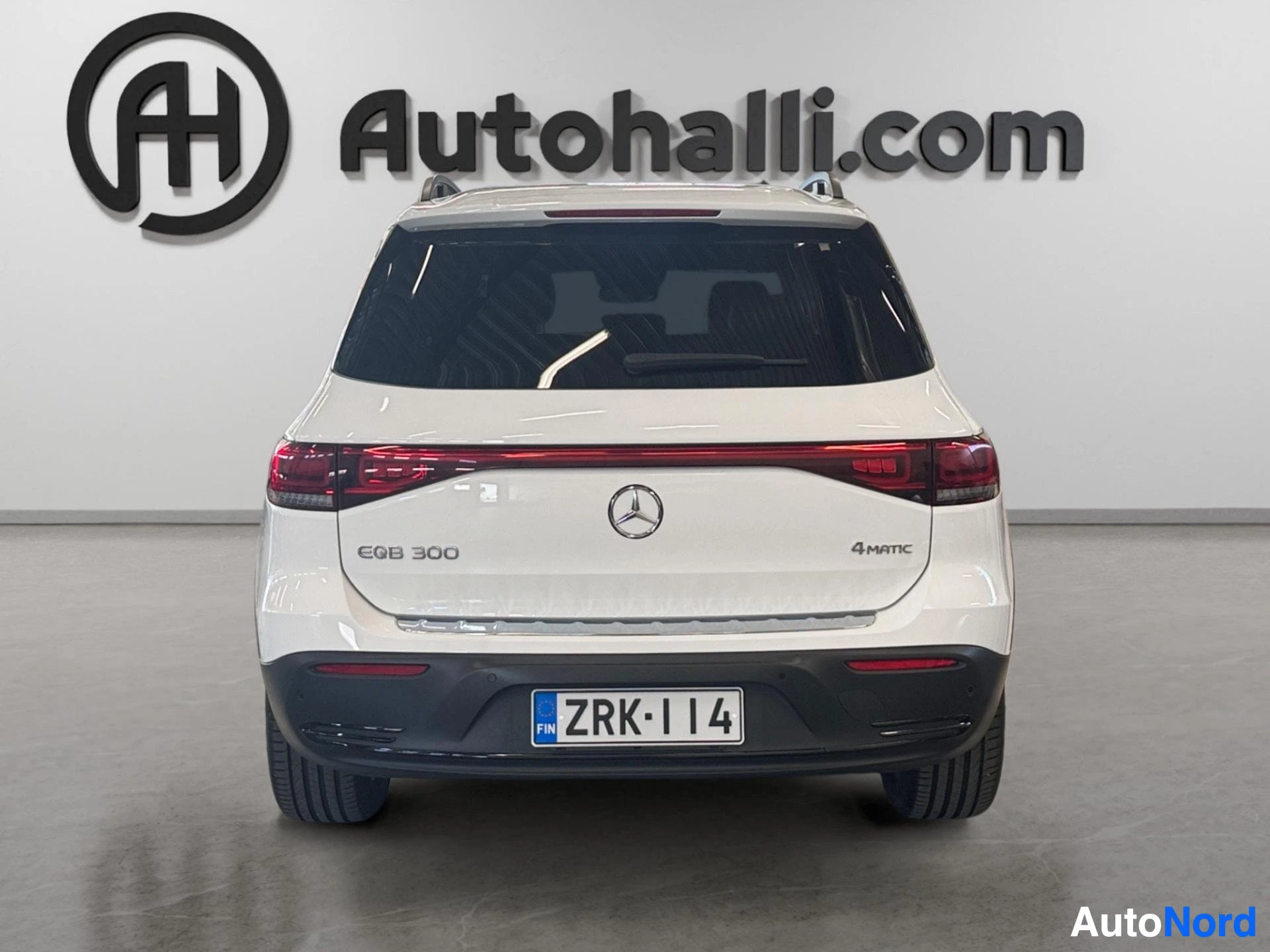 White Mercedes-Benz EQB 300 4MATIC rear view with red taillights and roof rails