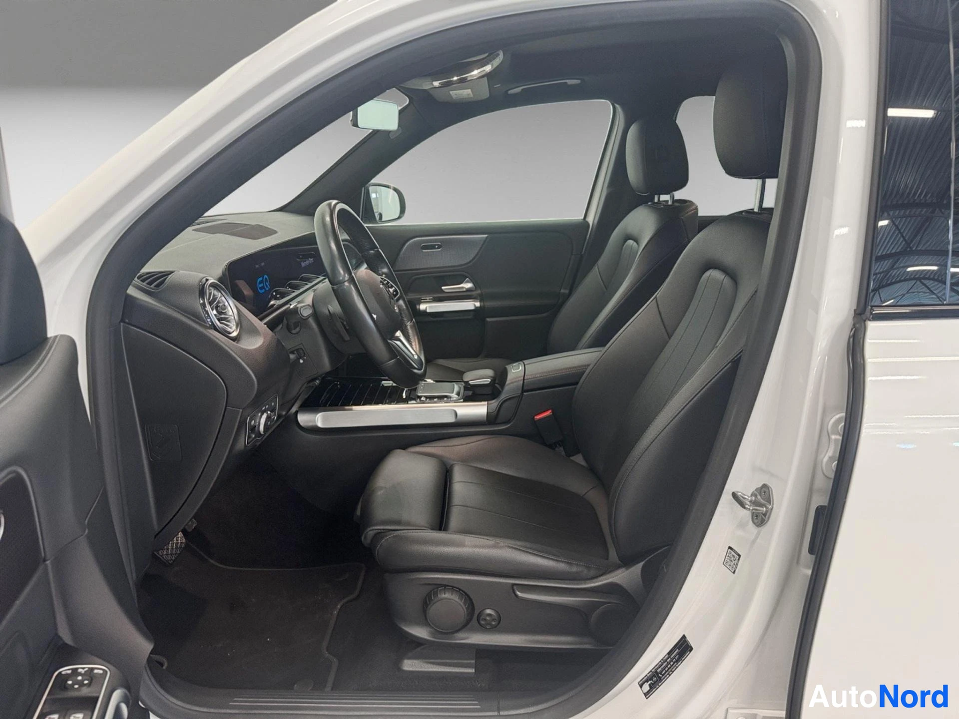 Front driver side interior with black leather seats and digital instrument cluster
