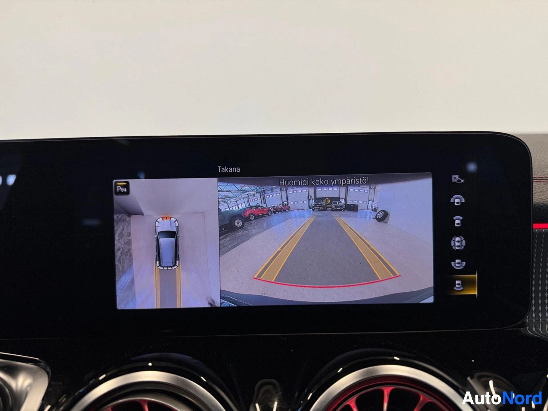 Dashboard display showing 360-degree camera view of vehicle in garage
