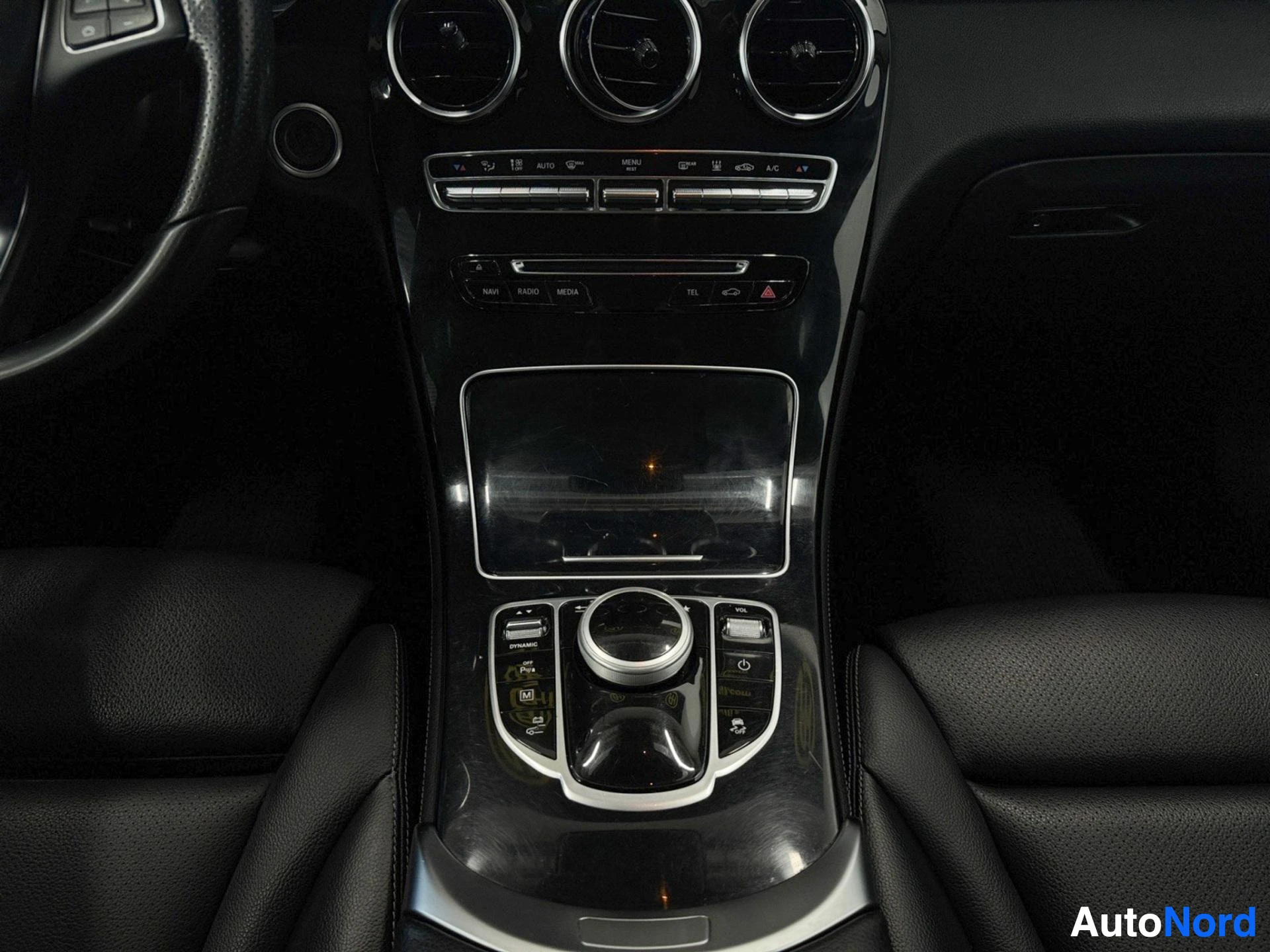 Center console with climate controls, infotainment screen, and transmission shifter