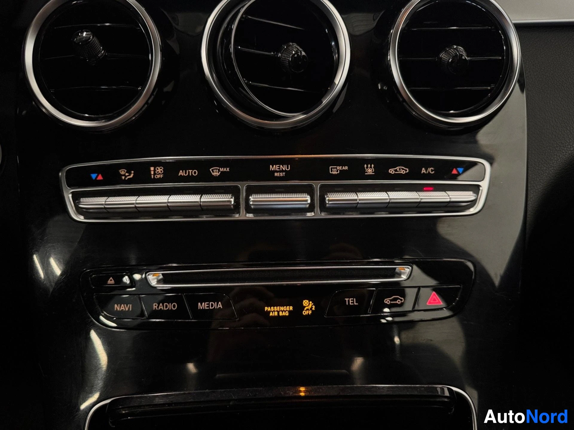 Dashboard air vents, control panel with climate and menu buttons.