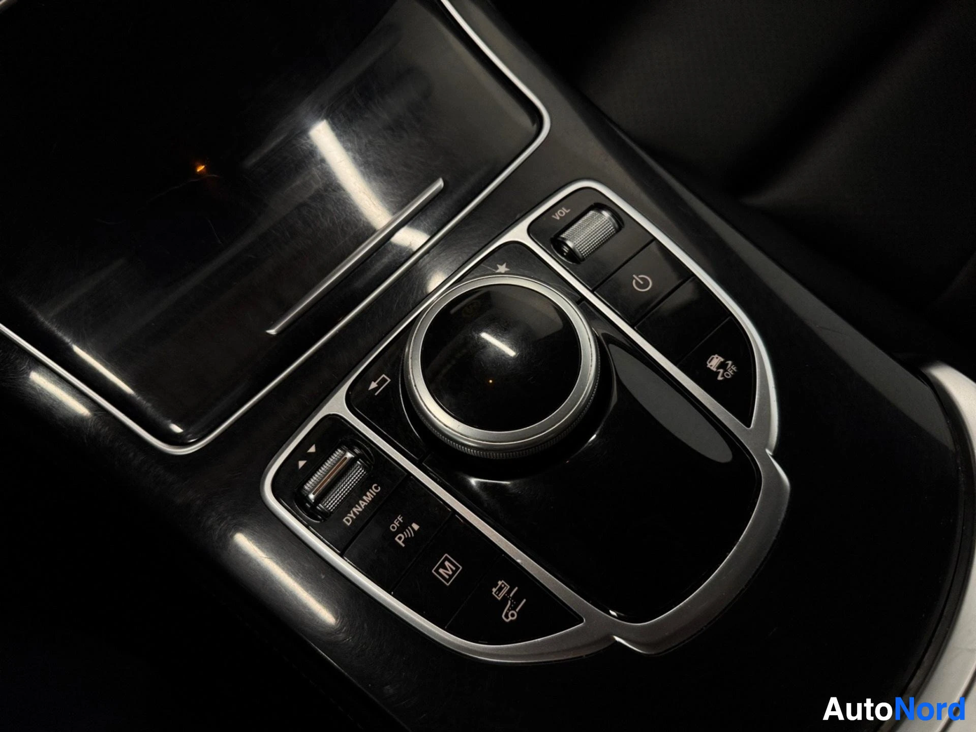 Central infotainment dial and dynamic mode control buttons on console.