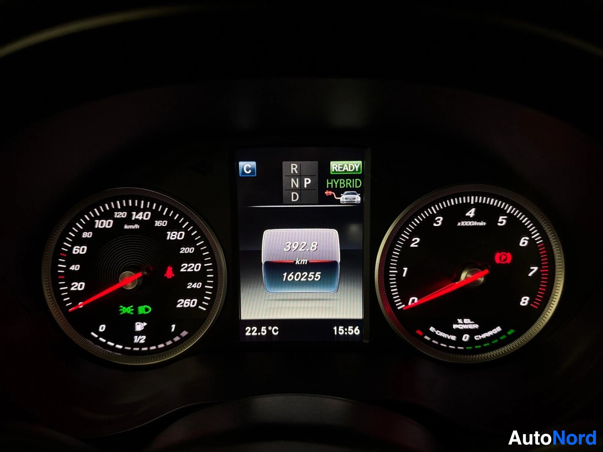 Digital instrument cluster displaying speedometer, tachometer, hybrid mode indicator, and mileage