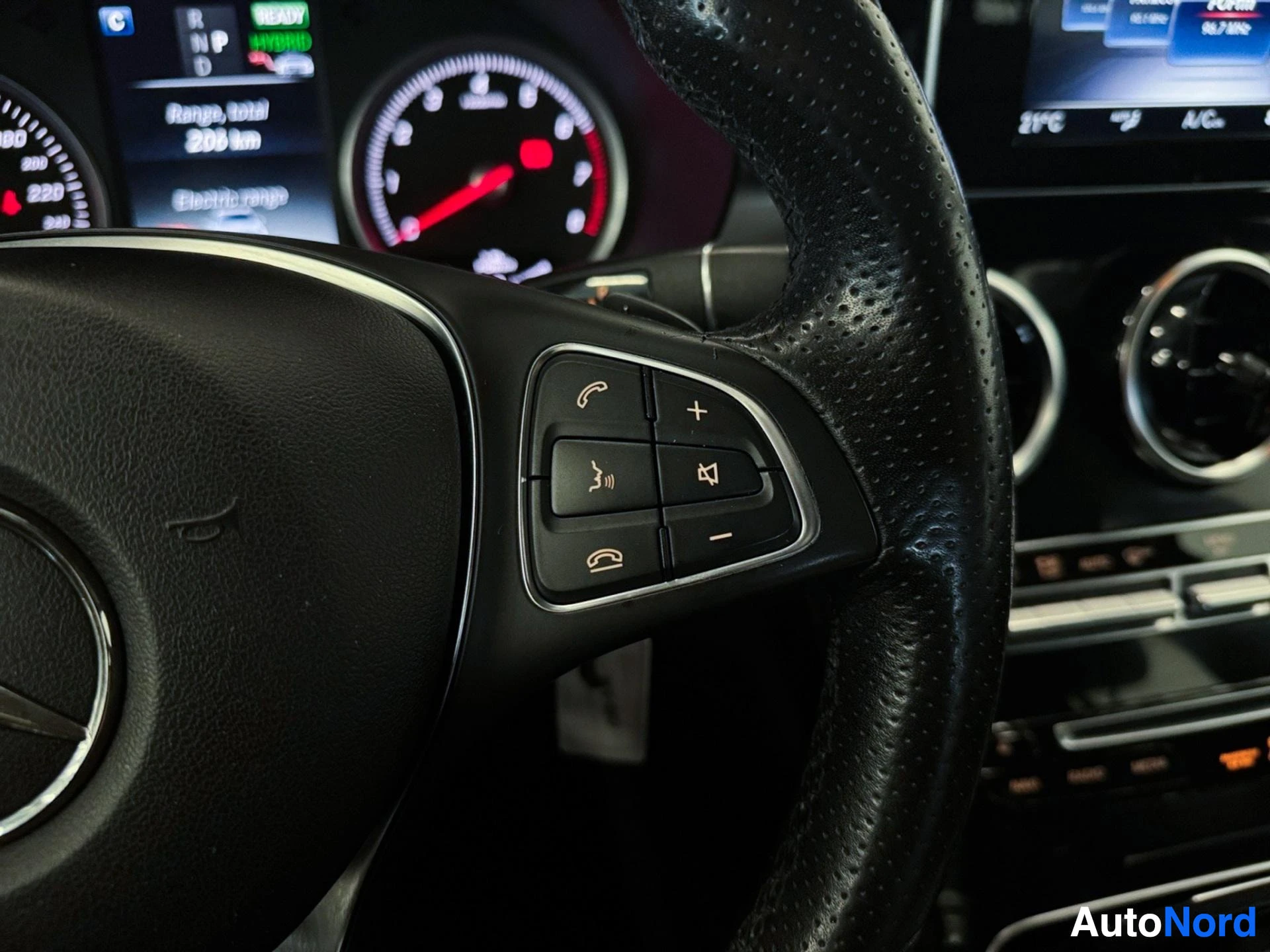 Left steering wheel controls with gauges and infotainment display
