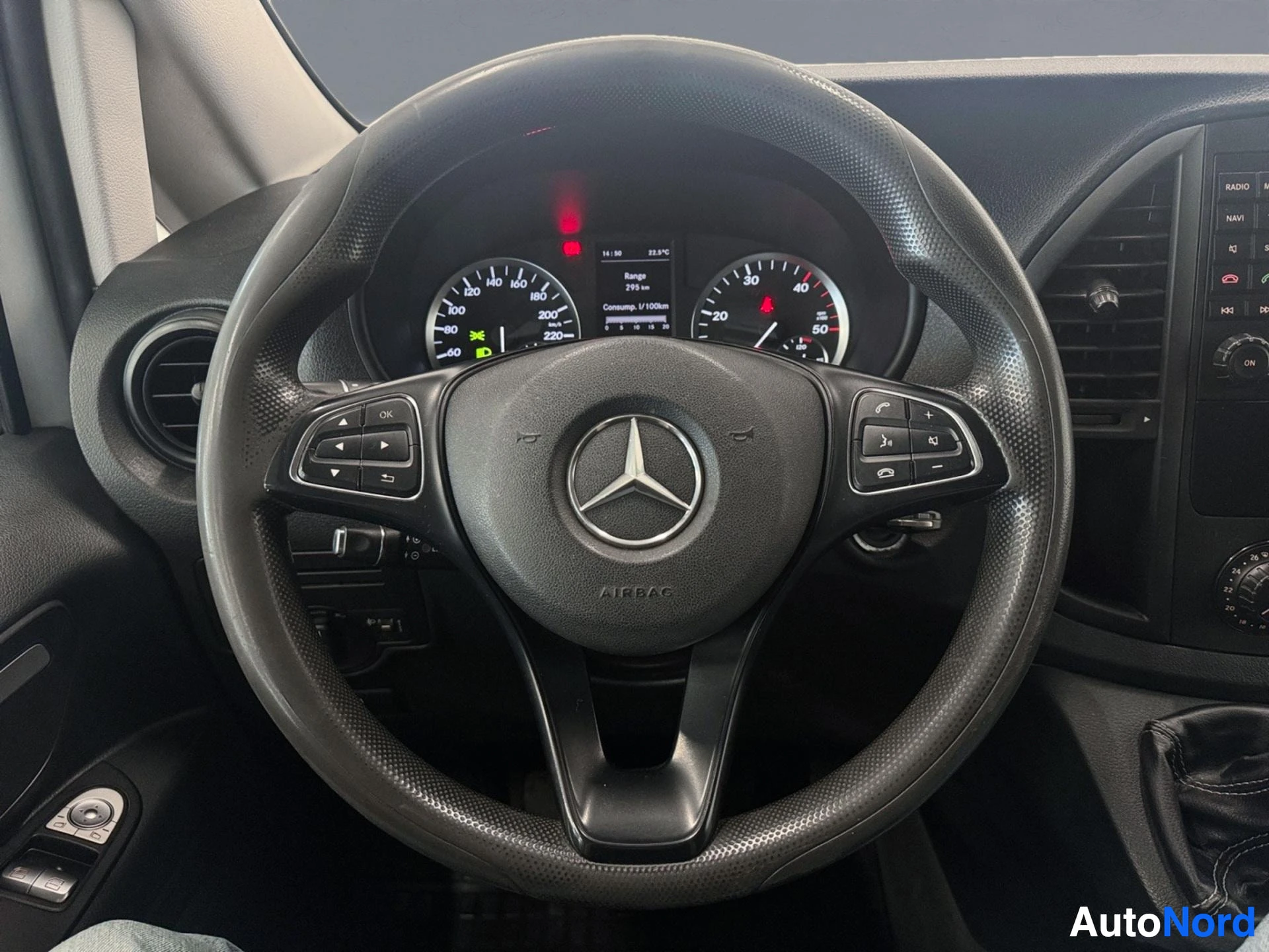 Steering wheel with Mercedes-Benz logo and control buttons